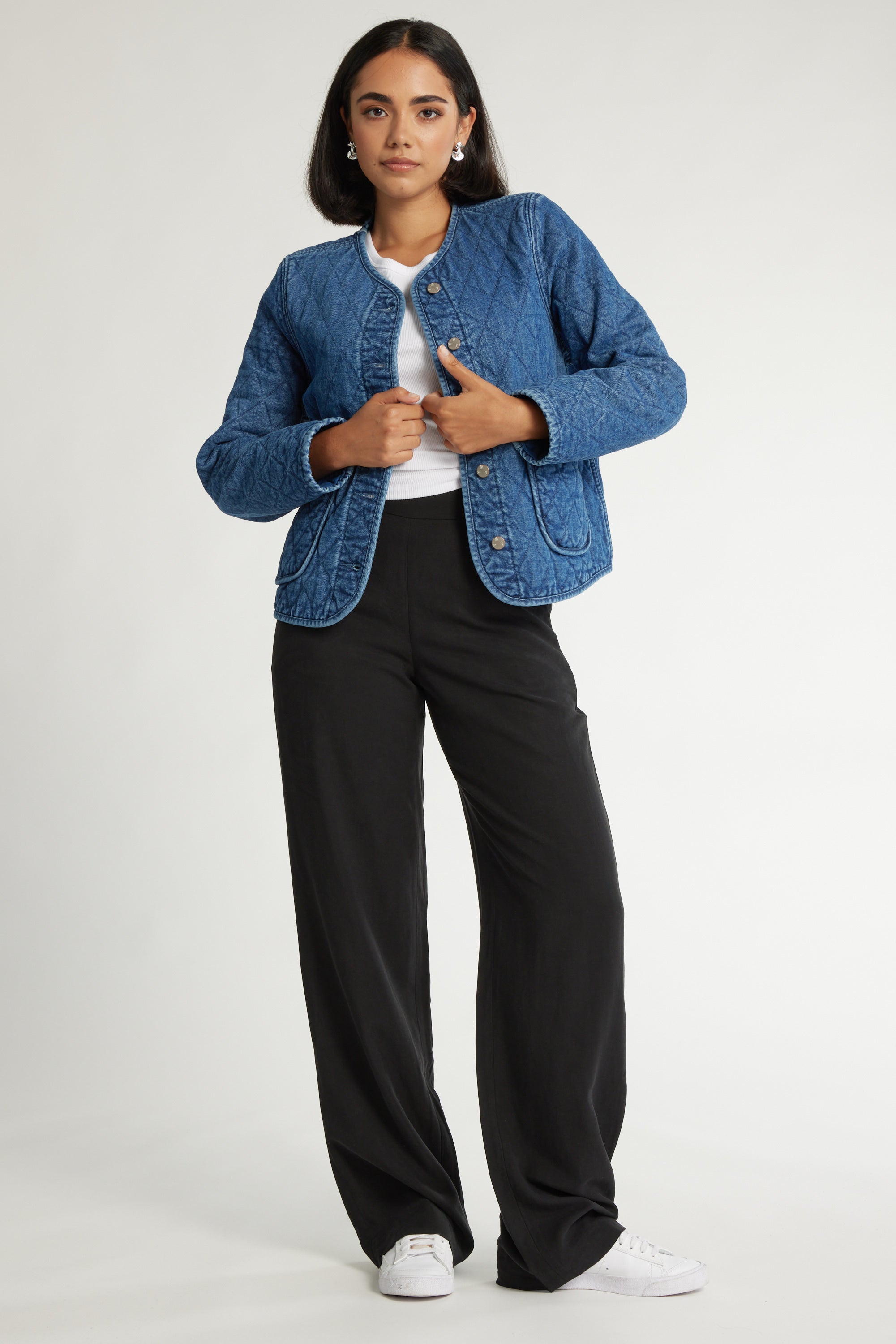 Woman in The Ultimate Wide Leg Pants by Max, blue quilted jacket, and white shirt standing.