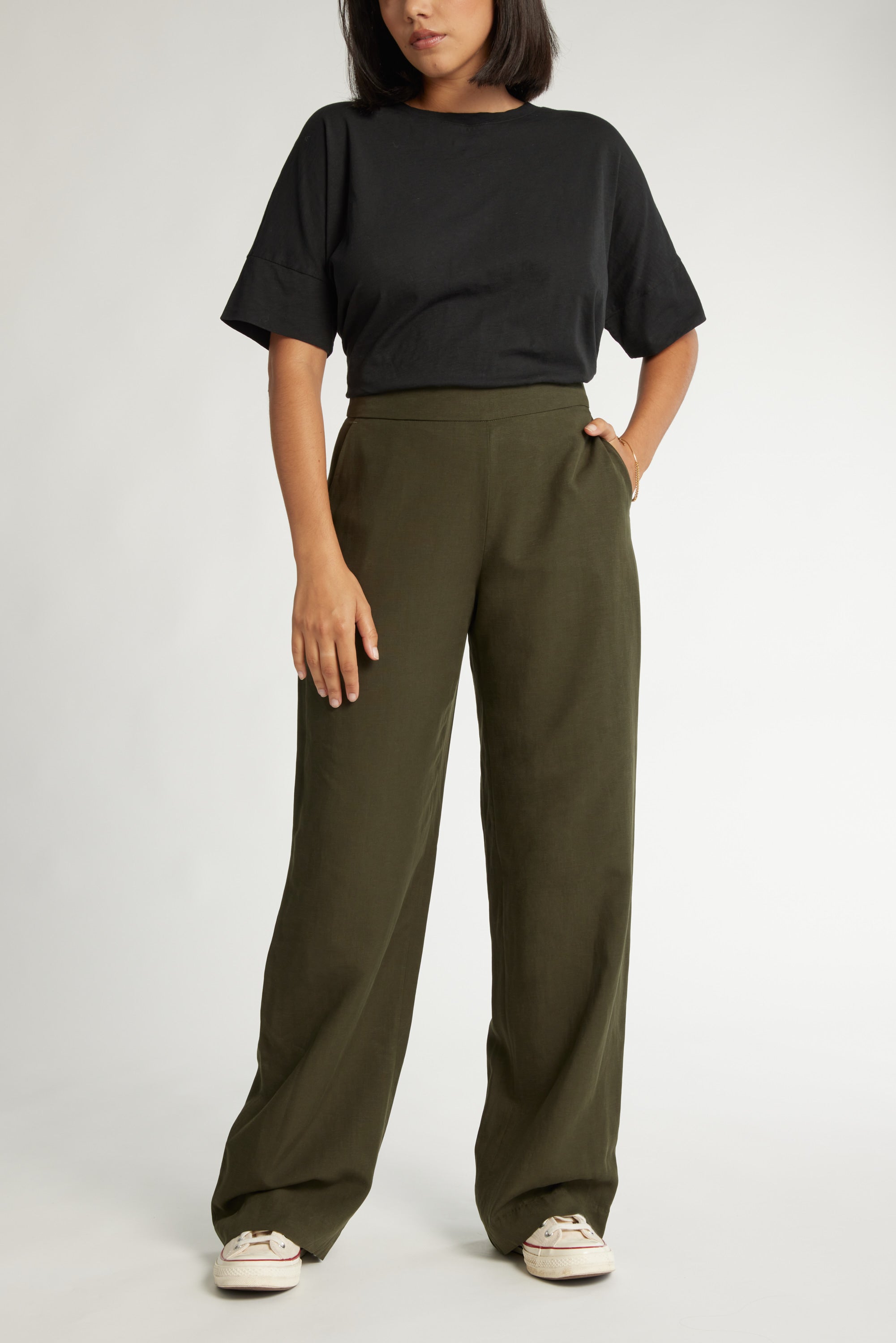 Woman in a black tee, Max The Ultimate Wide Leg Pants in olive, and white sneakers.