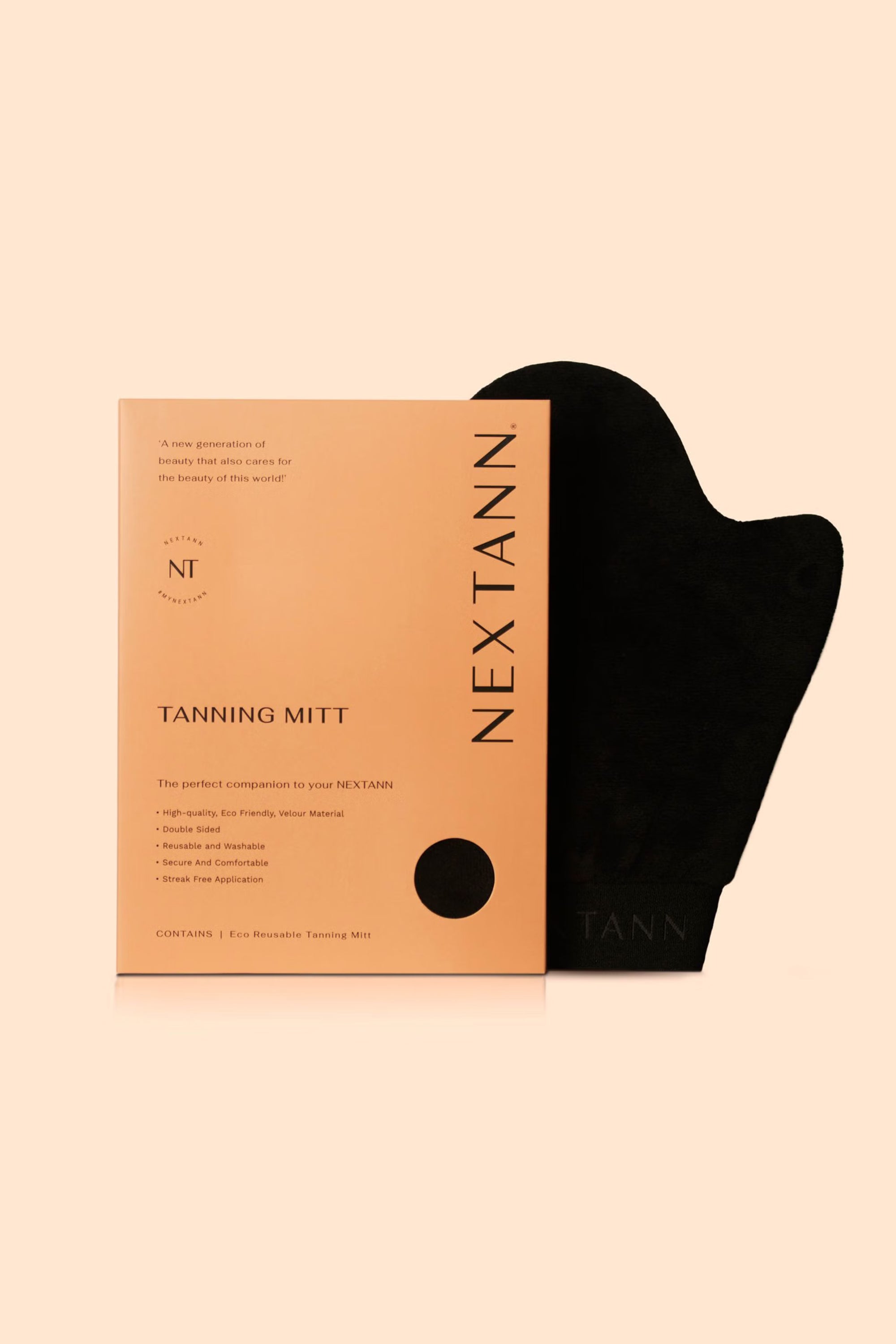A tan NEXTANN Nextann Tanning Mitt box stands next to a black vegan velour mitt on a pale beige background. The box displays features for achieving a streak-free tan in small text.