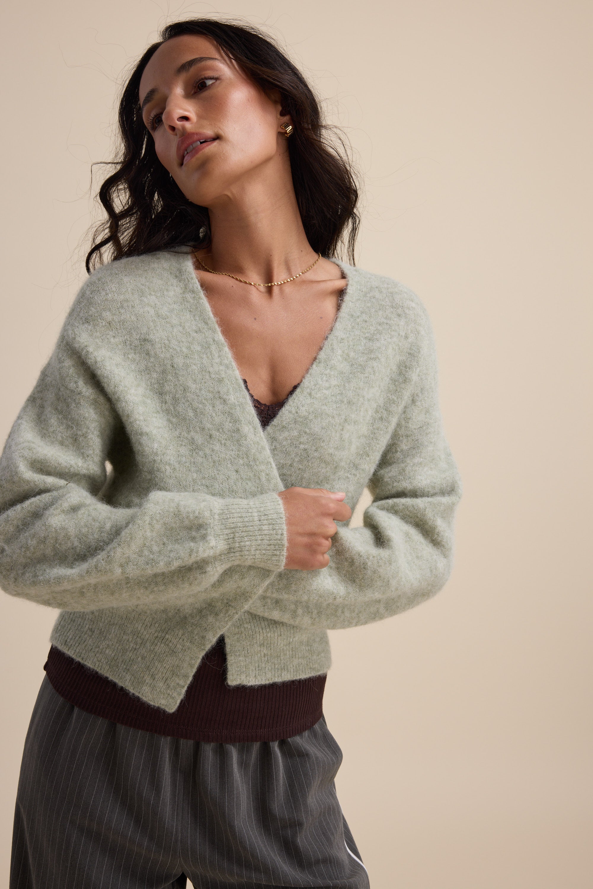 Woman in Max's The Ultimate Luxe Cardigan poses gracefully.