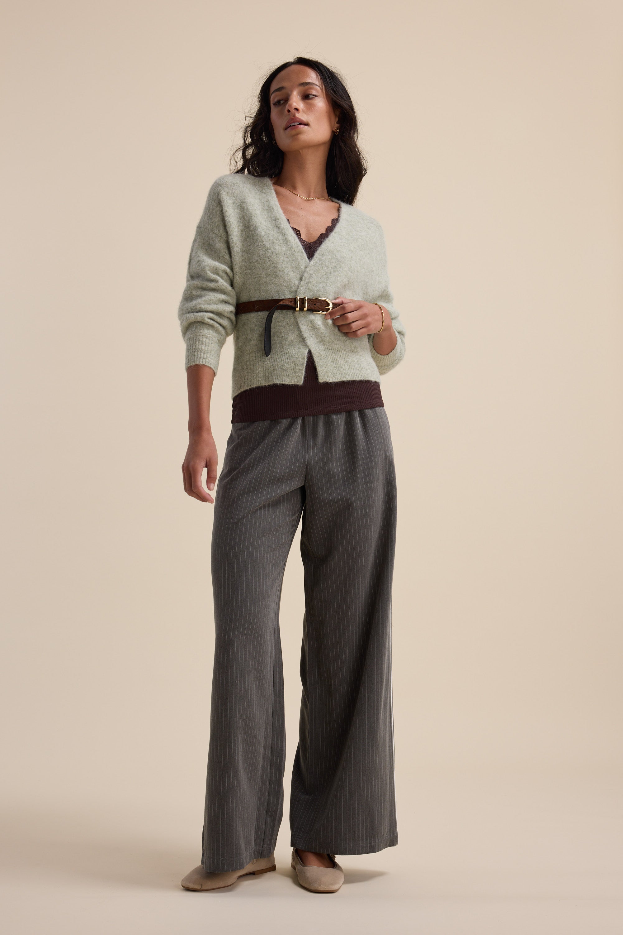 Woman in Max's The Ultimate Luxe Cardigan, balloon sleeves, wide-leg pants, and flat shoes.