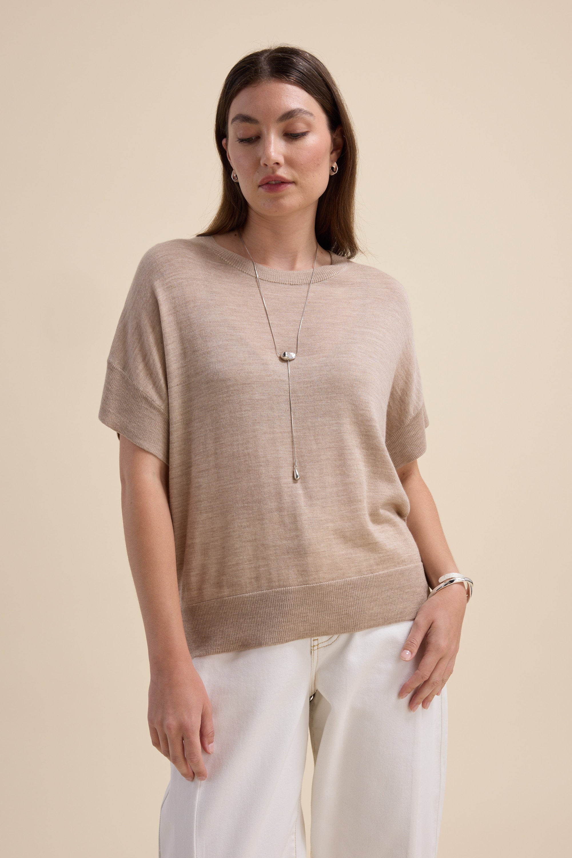 Woman in Max's Merino Silk Knit Tee stands against a plain background.