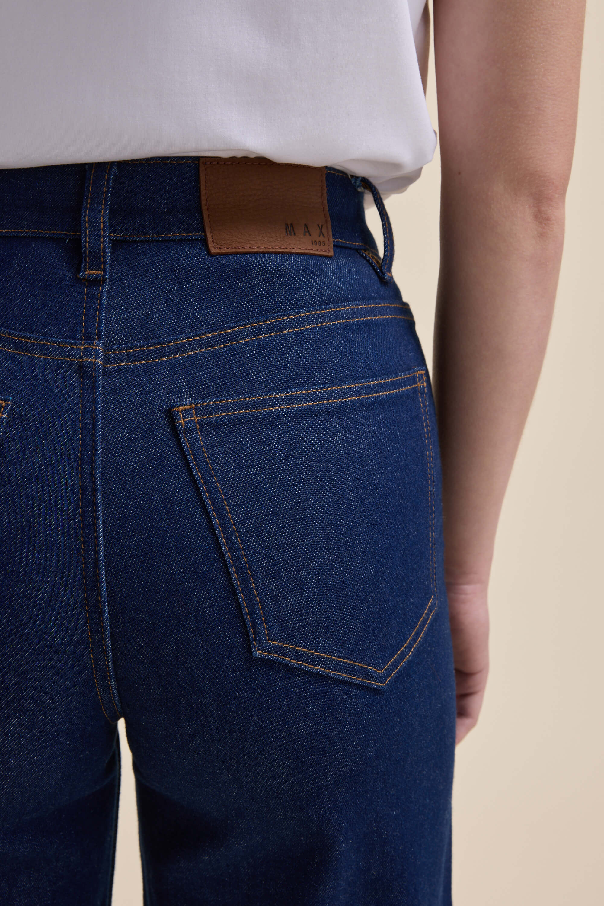 Model in Max Nevada Wide Jeans and white shirt, shown from back, waist down.