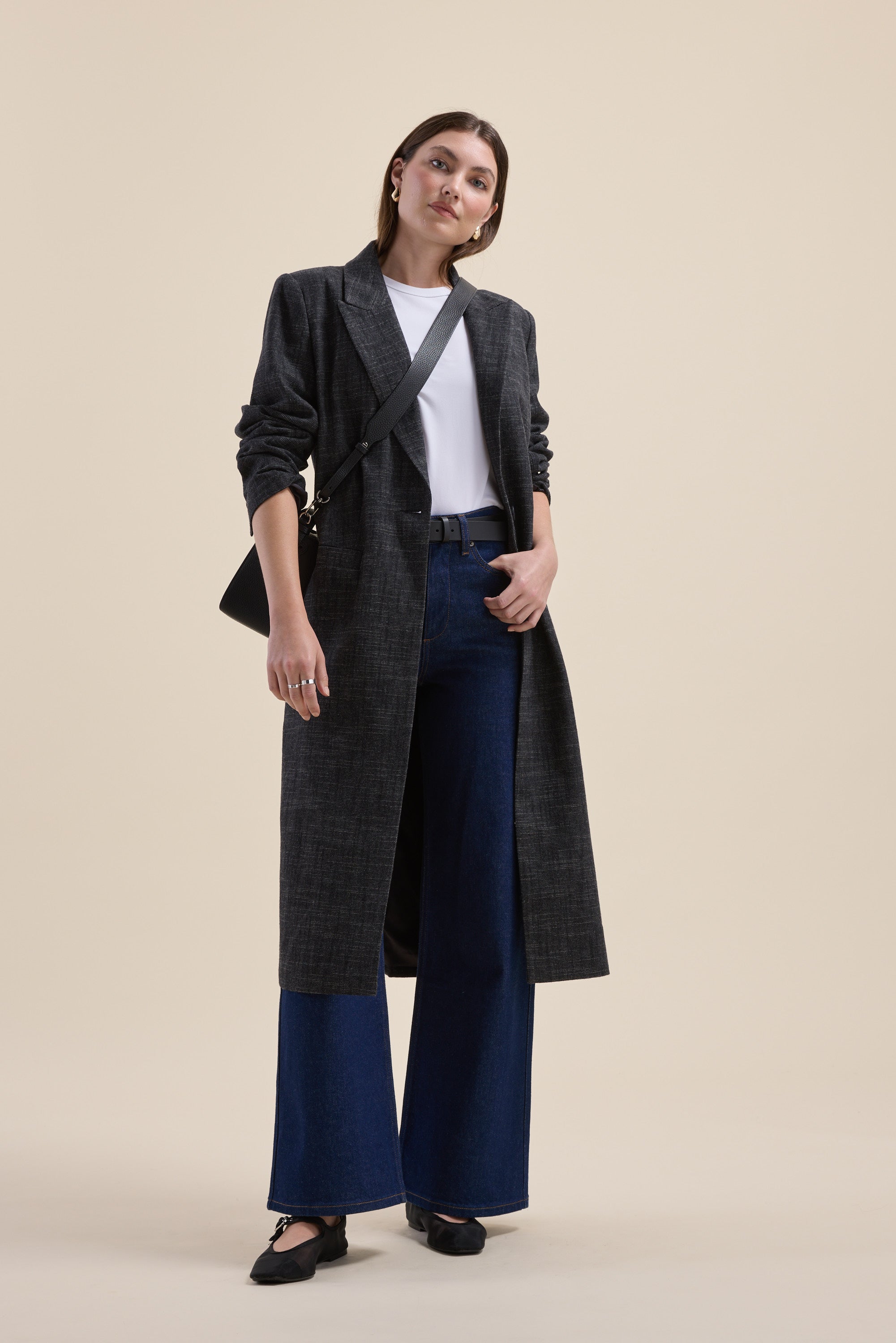 Woman in Max Nevada Wide Jeans, long dark coat, and white shirt, standing confidently.