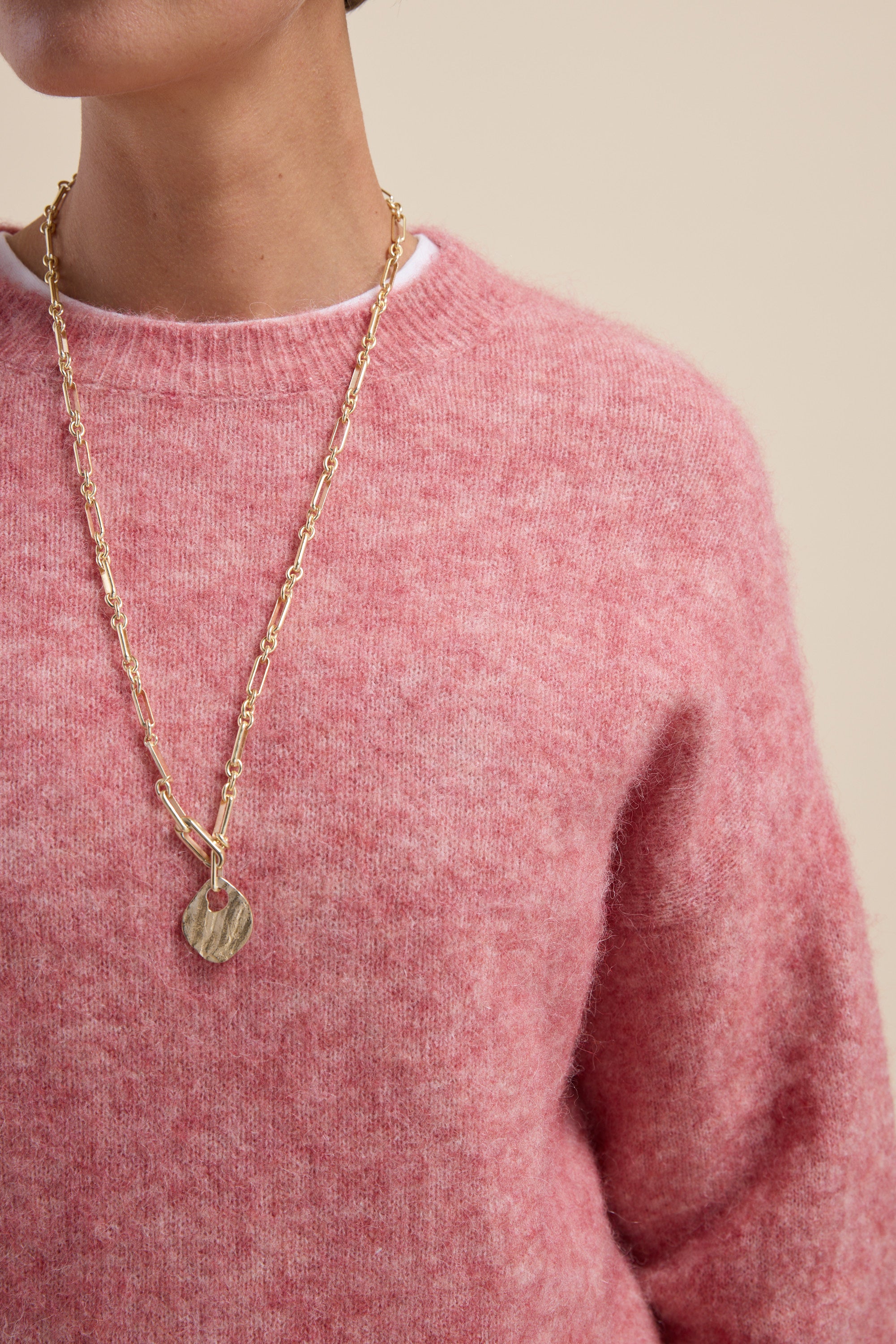 Person wearing a pink Max Hayley Luxe Whisper Crew Neck Sweater and a long gold pendant necklace.