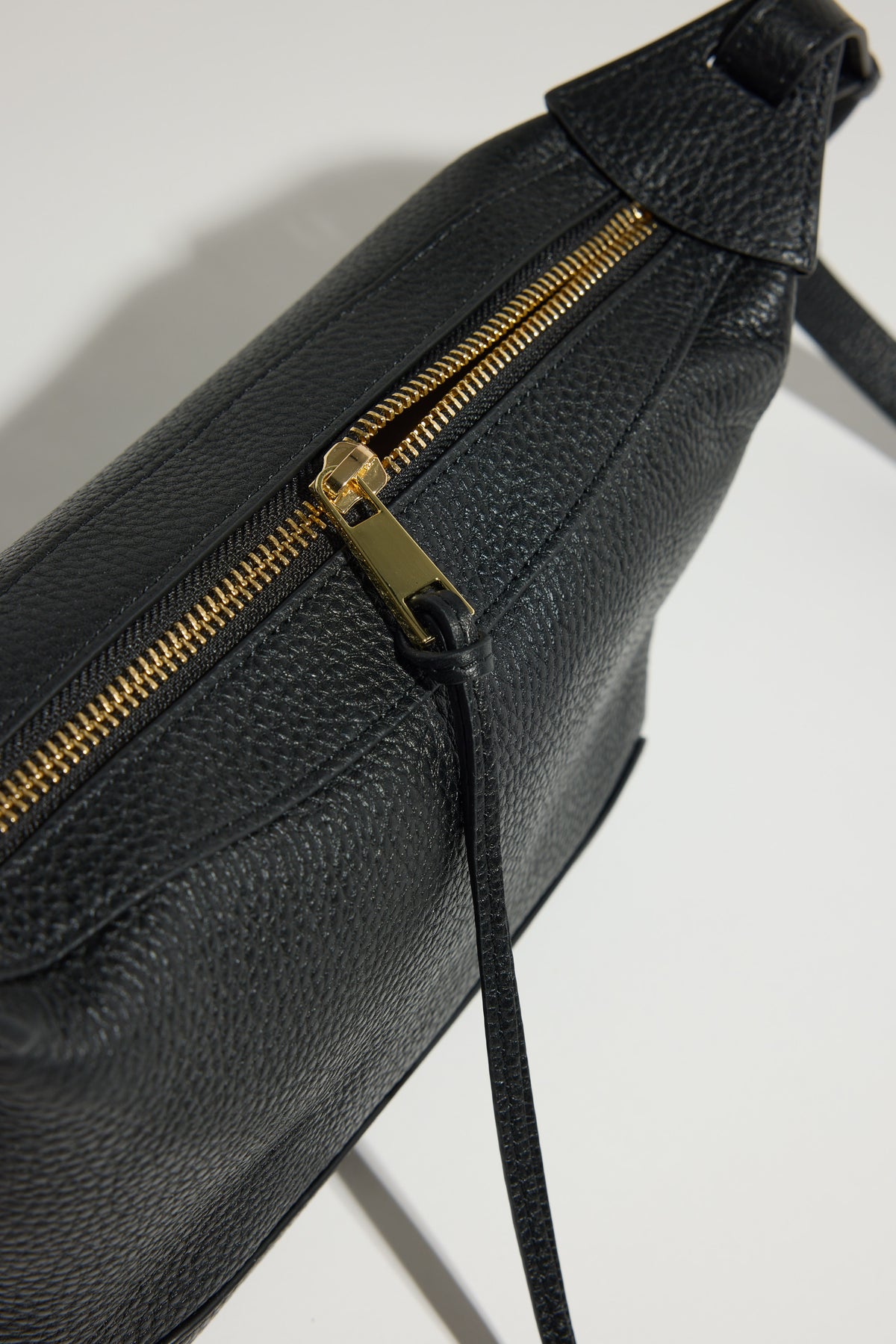 The Horse Mini Lou Bag: pebble leather, gold zip, adjustable strap, shown on white background.