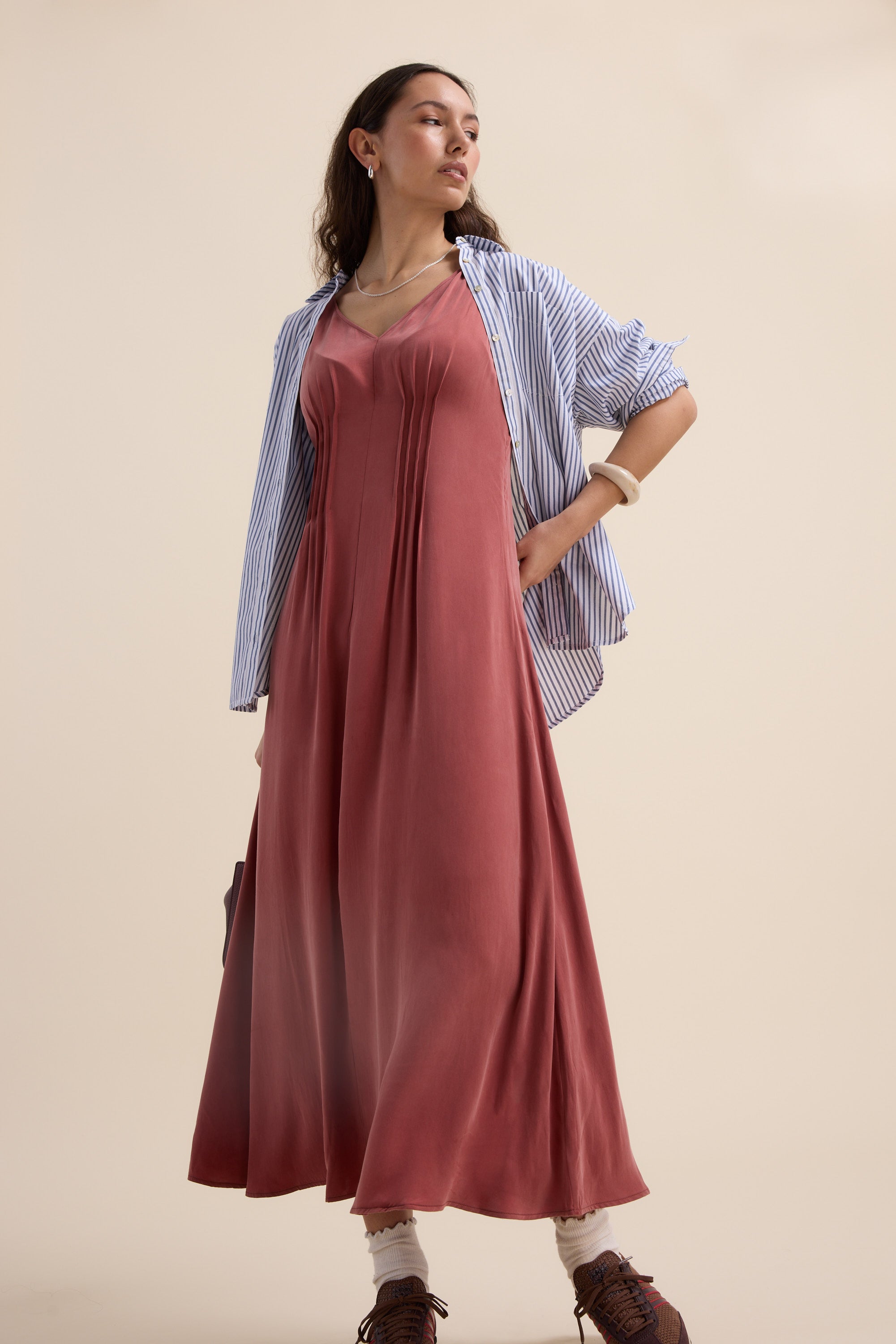 Woman wears the Max Cara Pleat Detail Dress, striped shirt, and brown shoes confidently.