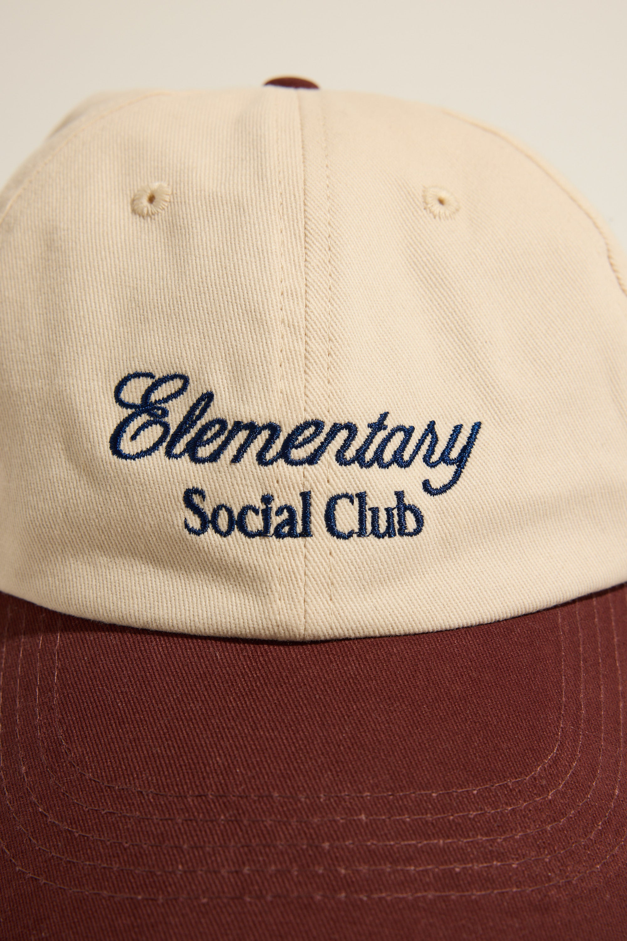 Max Elementary Contrast Brim Cap in beige and maroon with logo embroidered on the front.