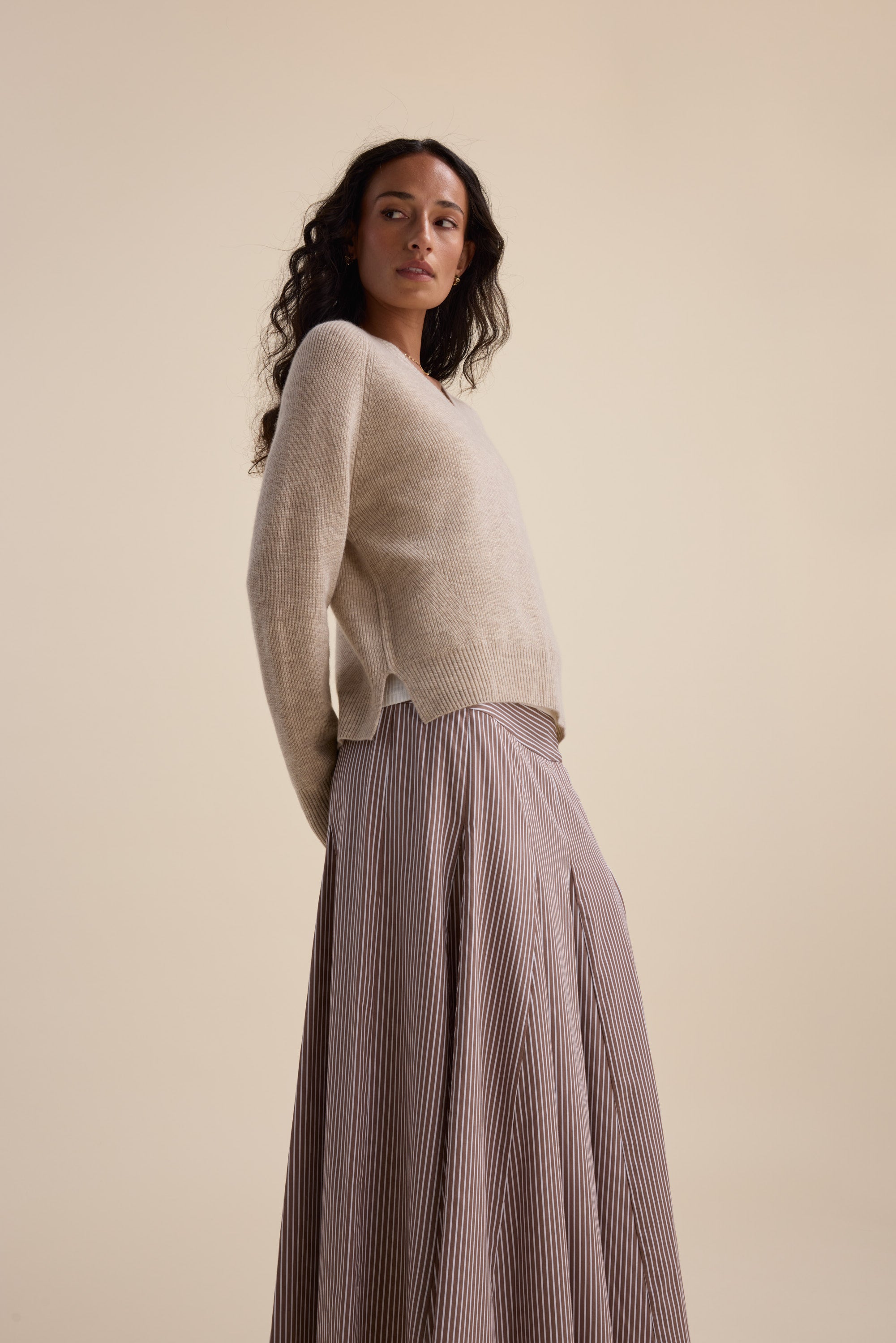 Woman in Elementary Cashmere Blend V Neck Sweater stands against a plain light background.