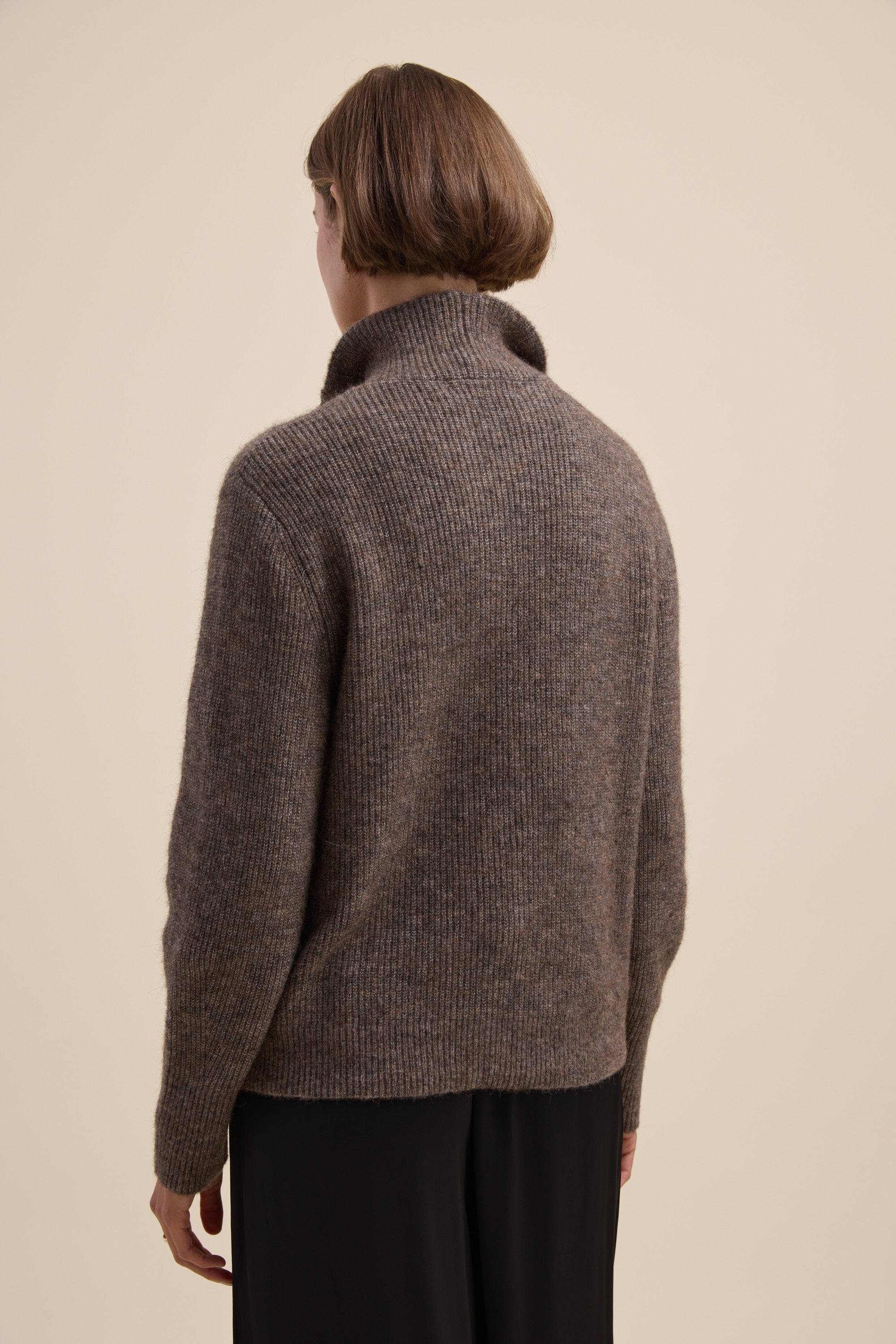 Person with short brown hair wears an Elementary Collar Detail Sweater, facing away from camera.