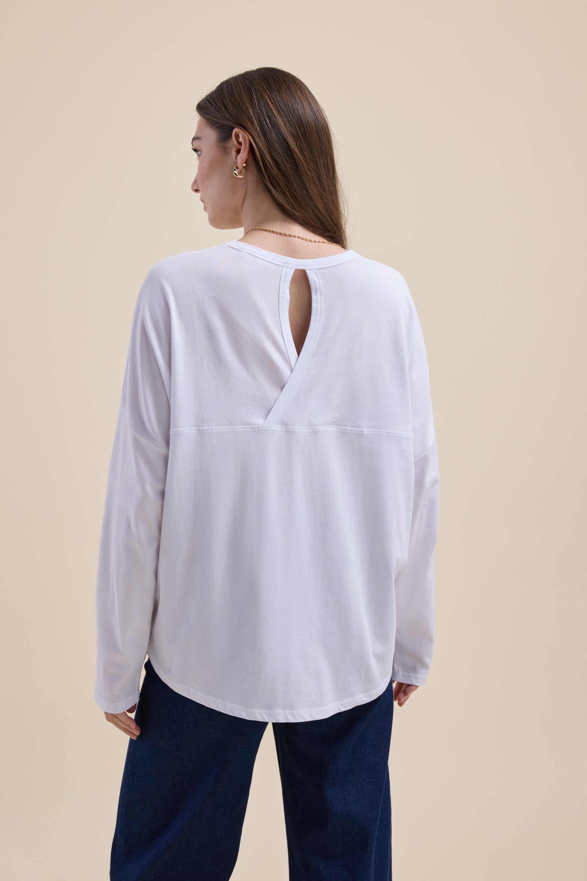 Woman in the Max Elementary Slouchy Long Sleeve Tee, featuring a back keyhole, facing away.