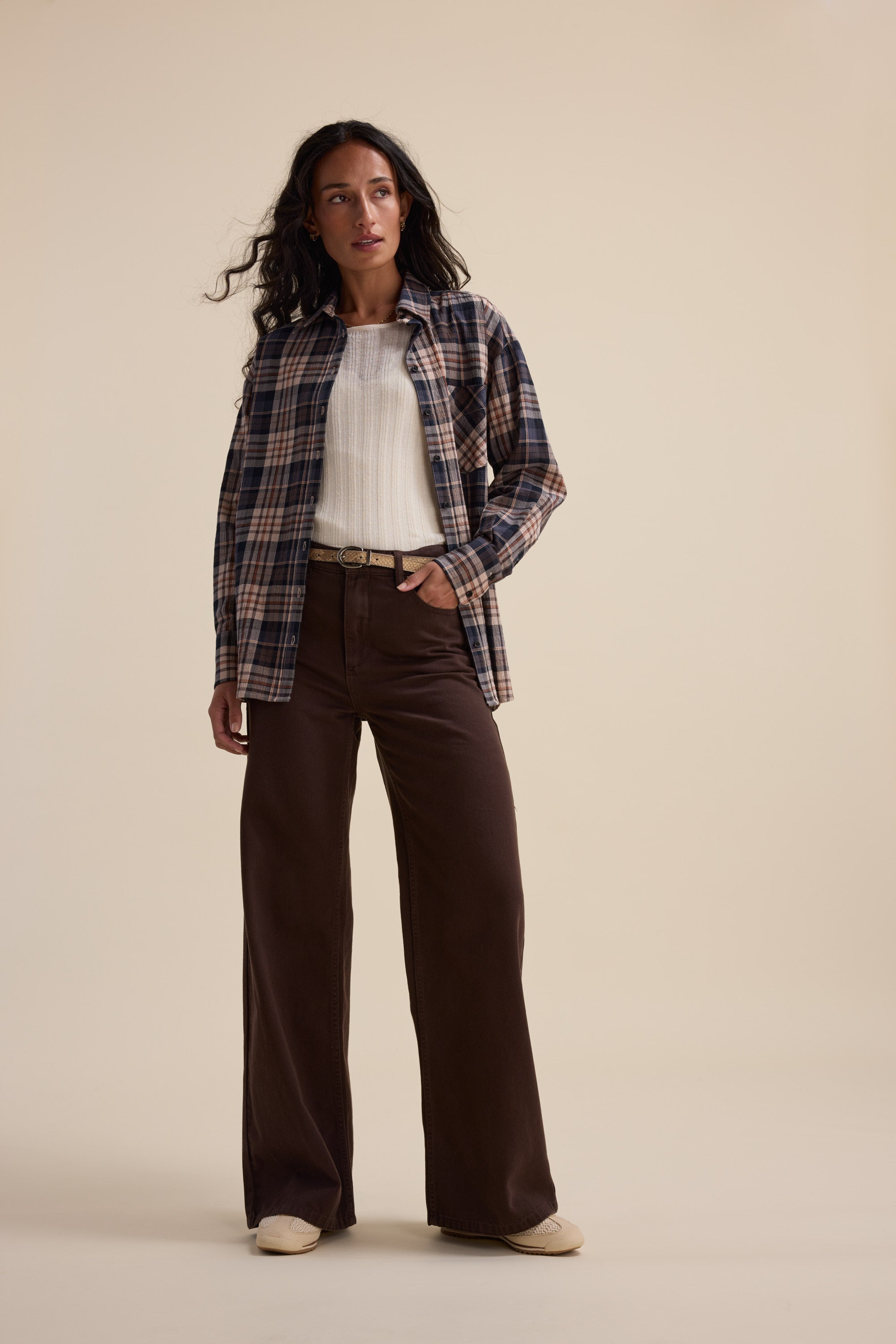 Woman in a plaid shirt, white top, and Max Alaska Wide Leg Jeans stands in a studio.