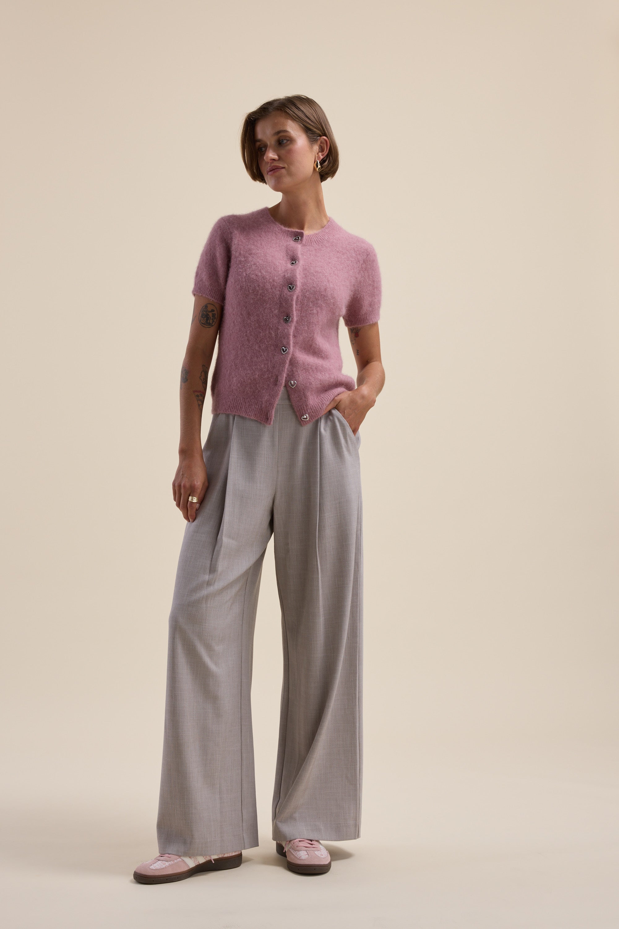 Person wearing a pink Max Adelaide Luxe Whisper Cardigan and loose gray pants.