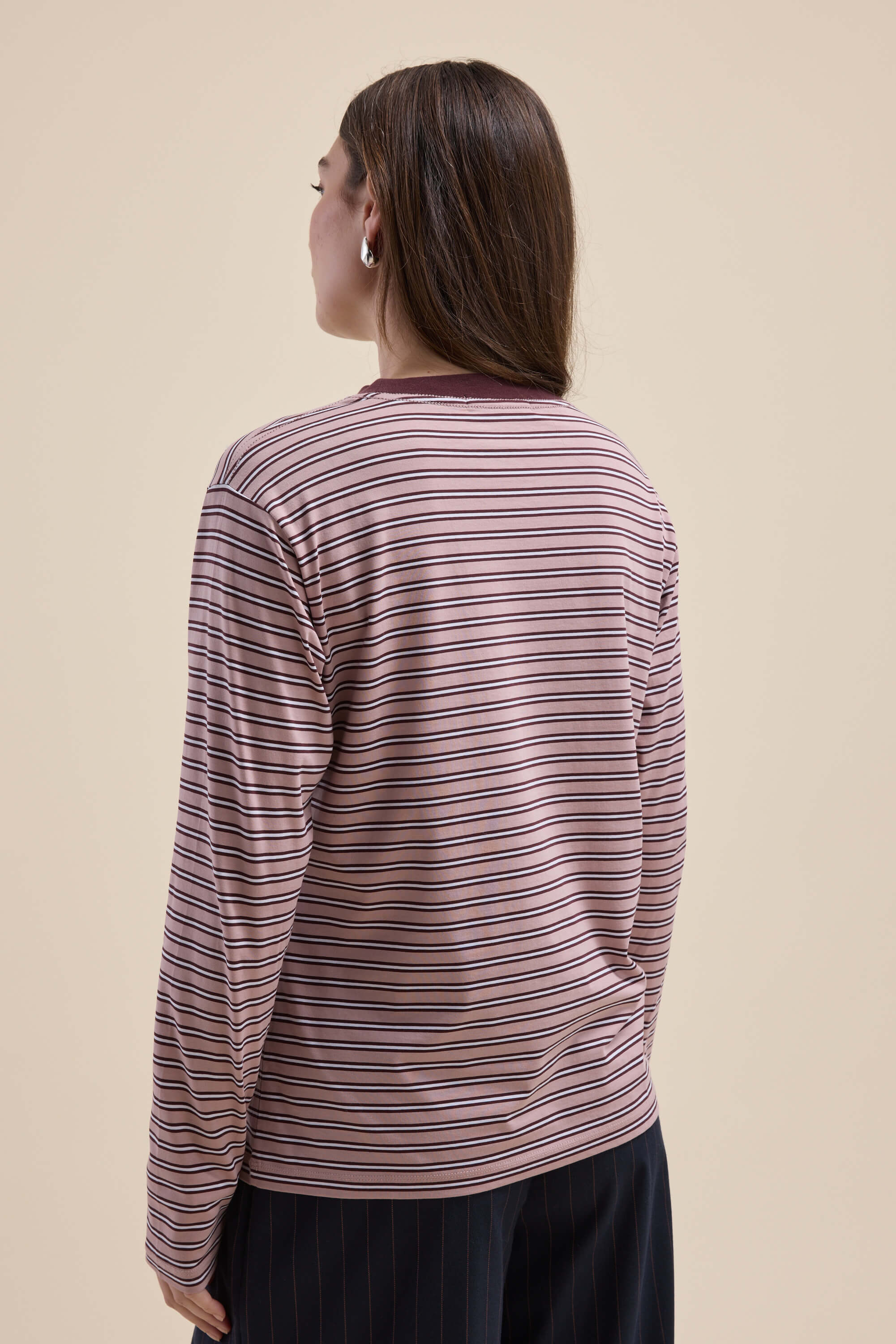 Person with long brown hair in a Max Carmen Long Sleeve Stripe Tee, seen from the back.