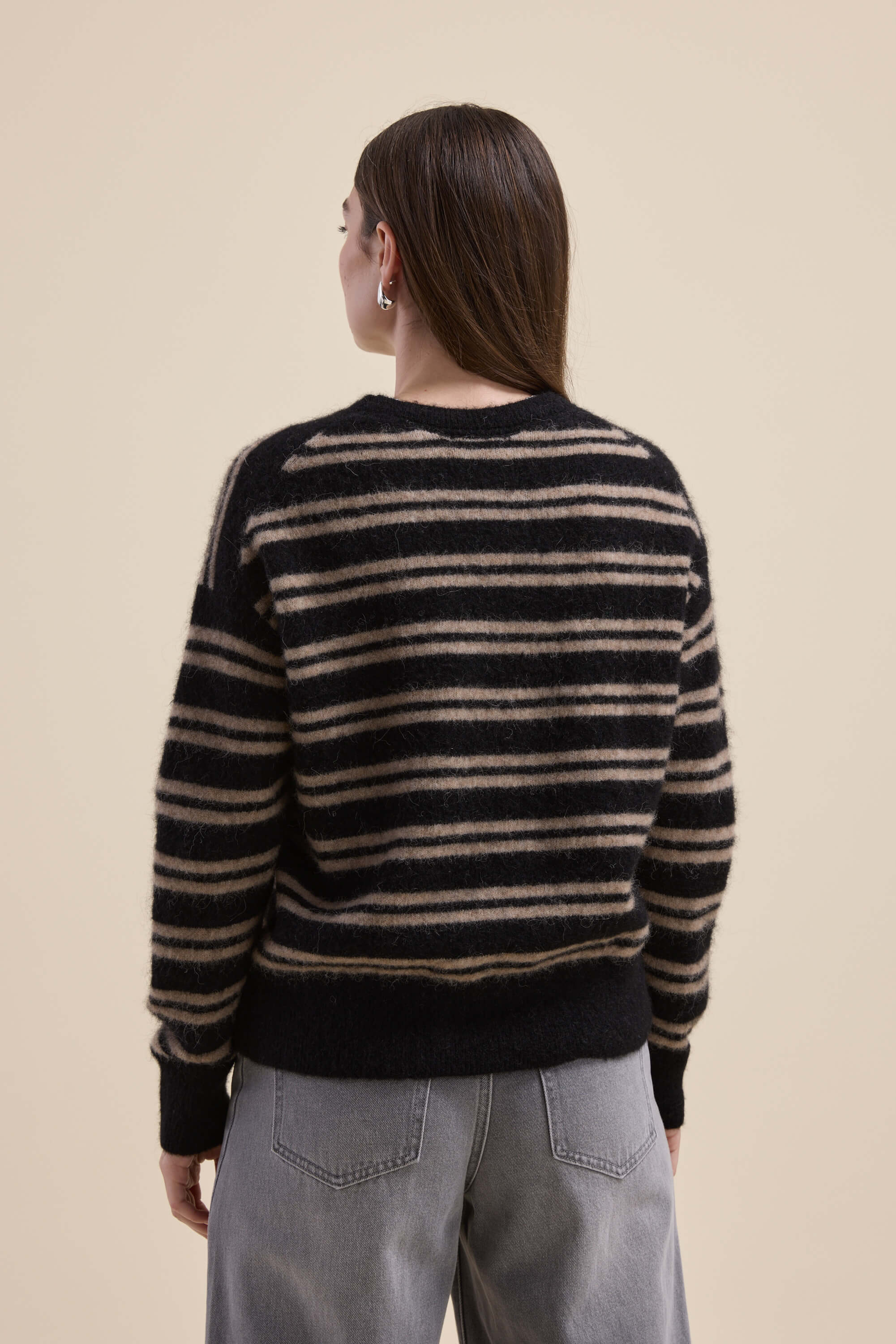 Woman in a Max Juno Luxe Whisper Sweater and gray jeans, shown from the back.