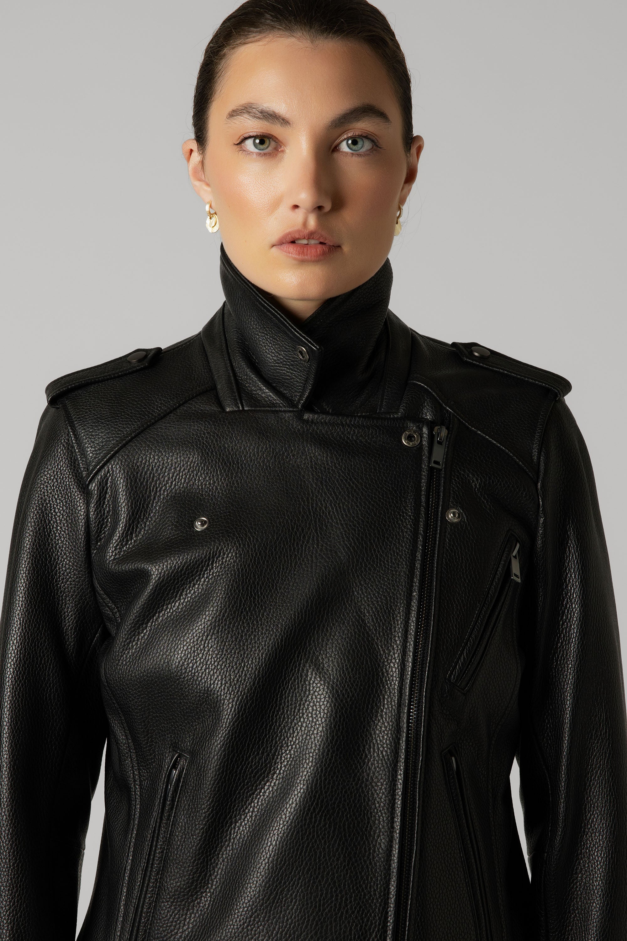 Woman in Max's The Perfect Leather Biker Jacket with high collar, against a gray background.