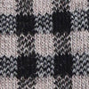 Close-up of knitted fabric with a black, white, and gray checkered pattern.