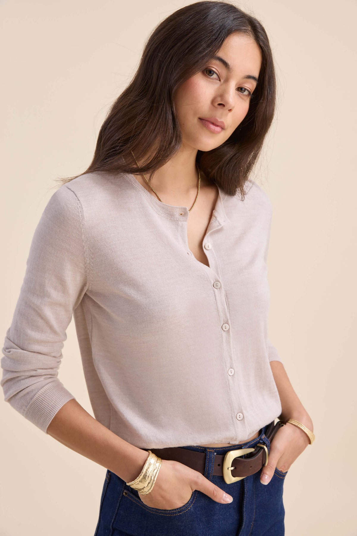 Woman in Max’s Merino Silk Cardigan and dark jeans, standing with hands in pockets.
