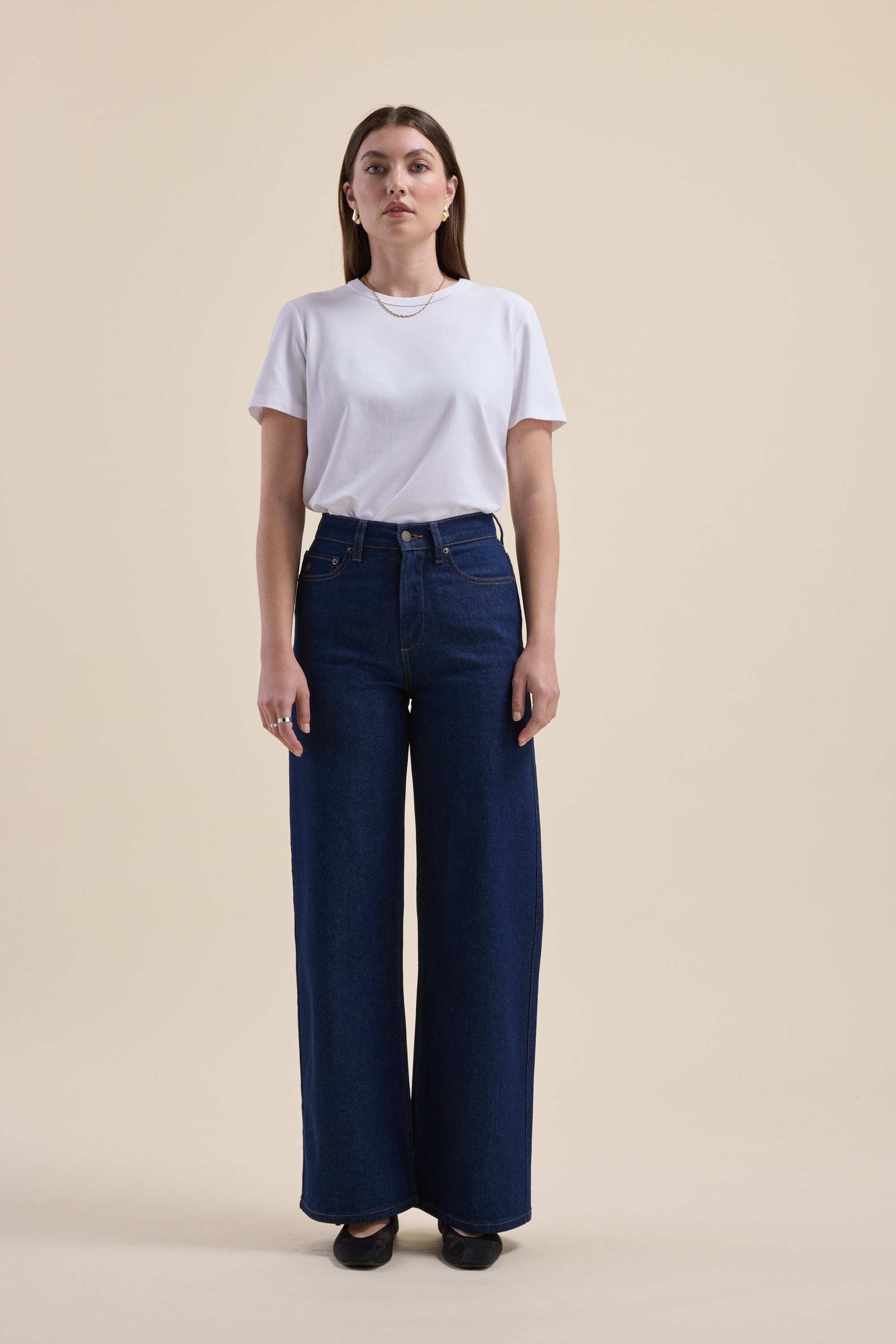 Woman in white tee and Max Nevada Wide Jeans against a plain beige background.