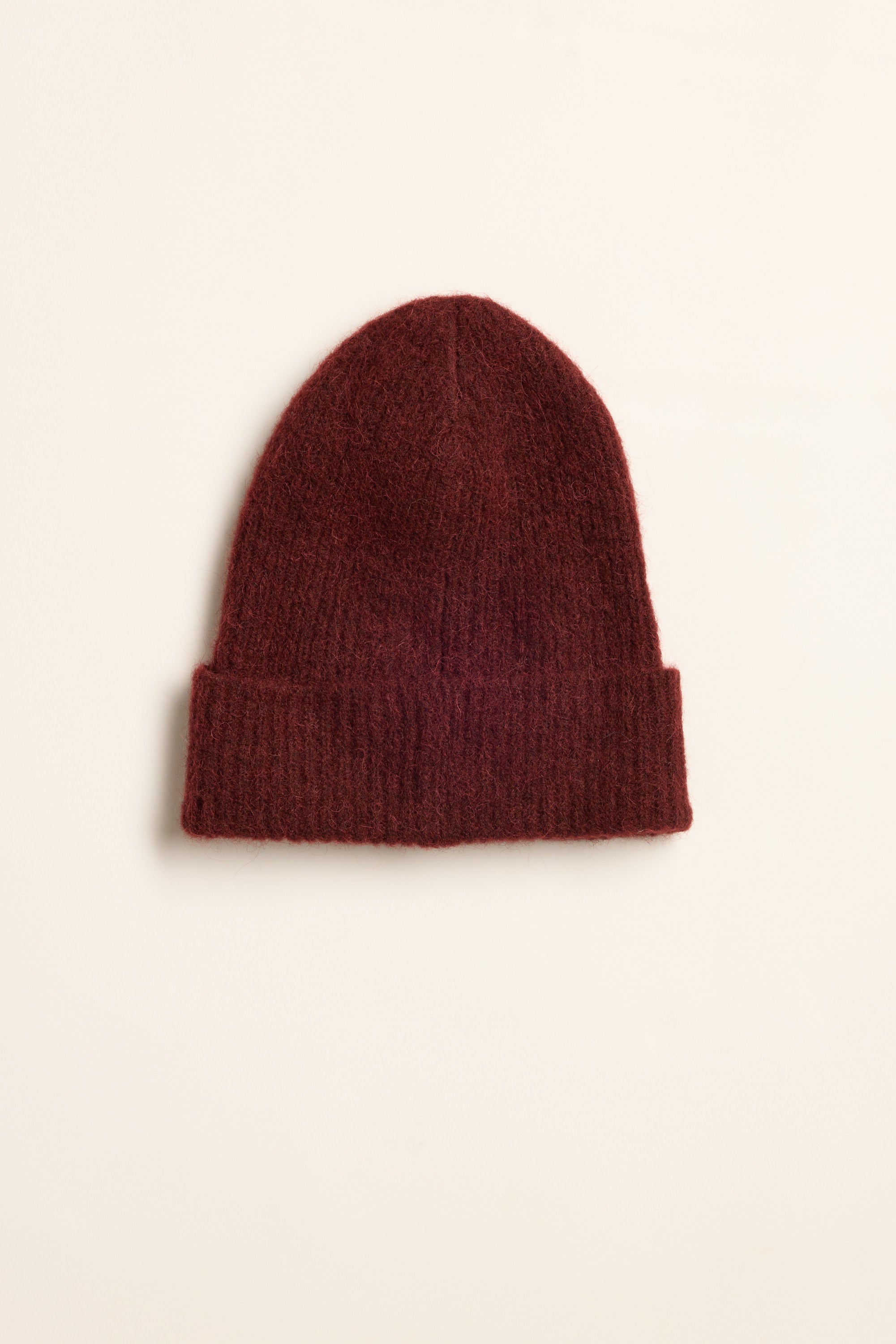 The Max Georgia Luxe Whisper Knit Beanie is a cosy dark red wool-alpaca hat with folded brim.