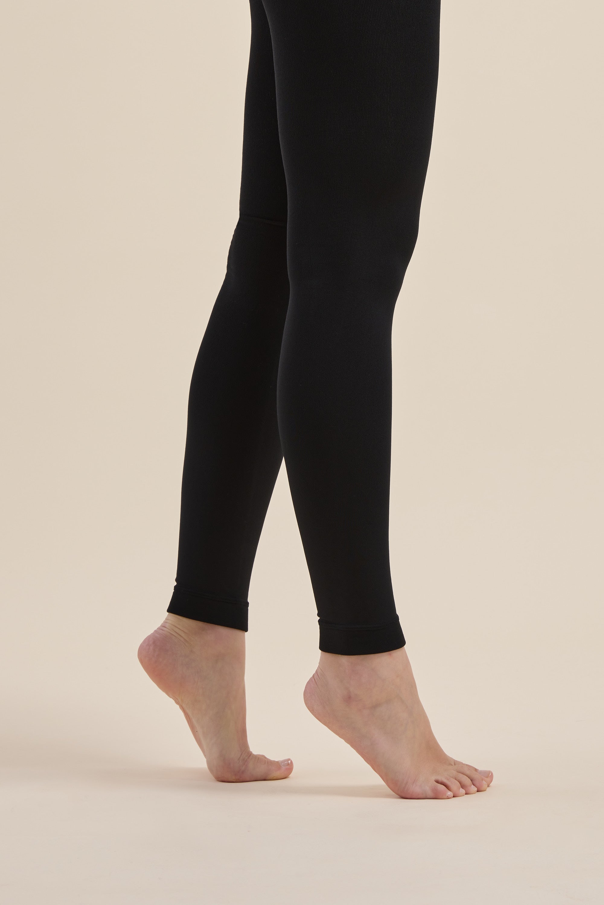 Model in Max Recycled Fleecy Legging, standing on tiptoes, shown from knees down.