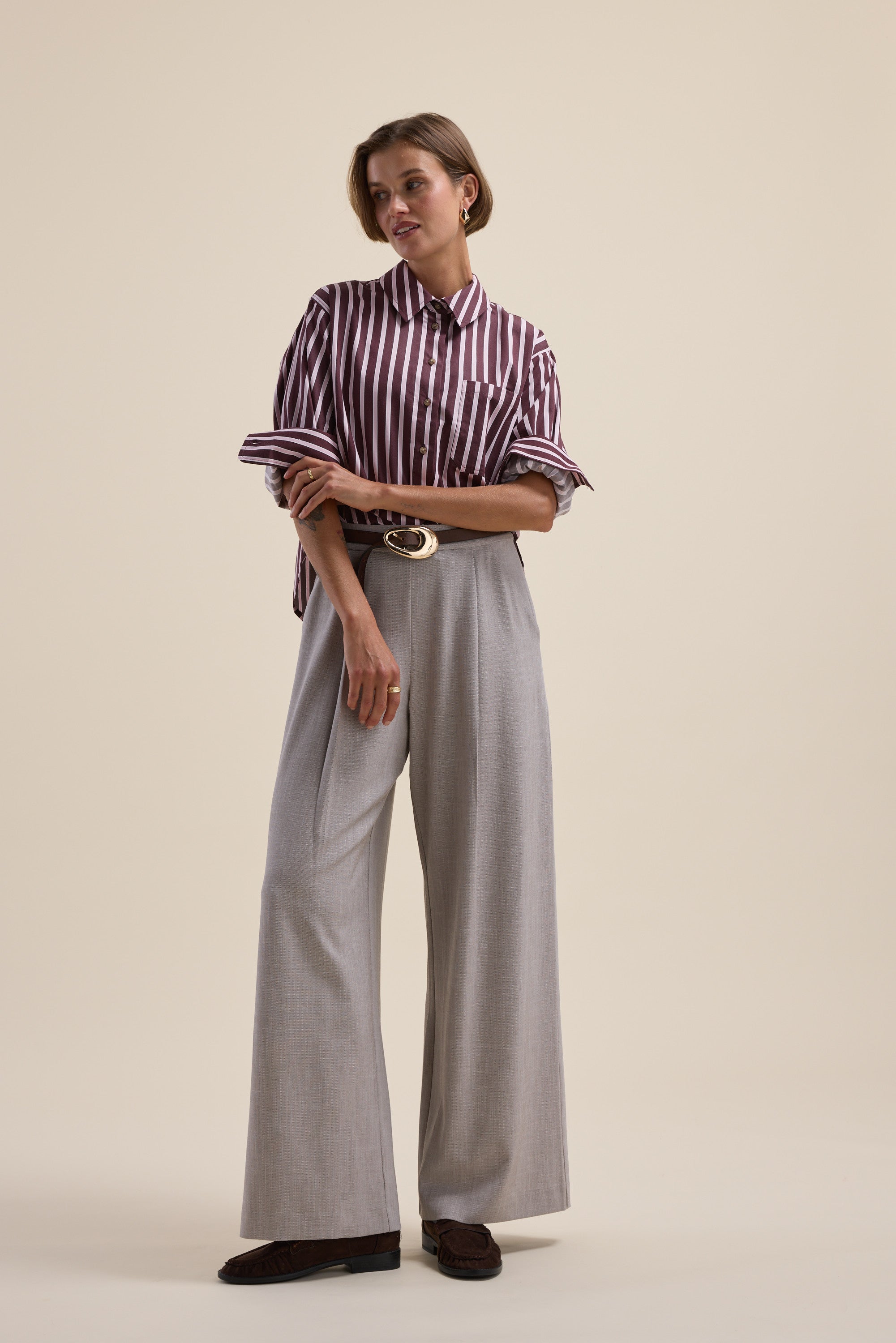 Woman wears Max Leah Stripe Detail Shirt and wide-leg gray trousers against a plain background.