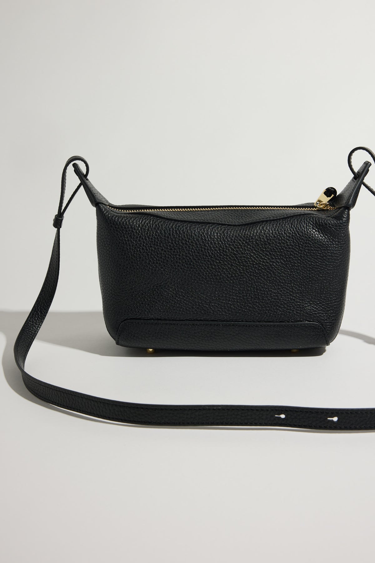 The Horse Mini Lou Bag in black leather with gold zipper and adjustable strap, by The Horse.