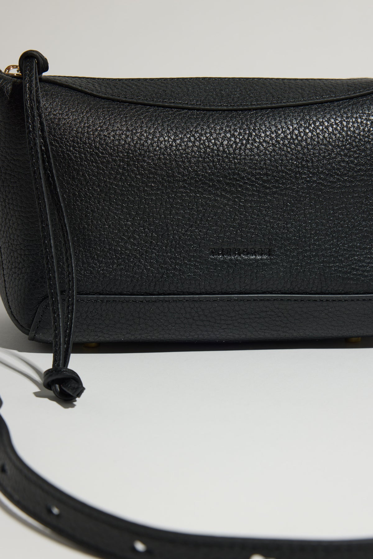 The Horse Mini Lou Bag: black pebbled leather crossbody with knotted, adjustable strap.