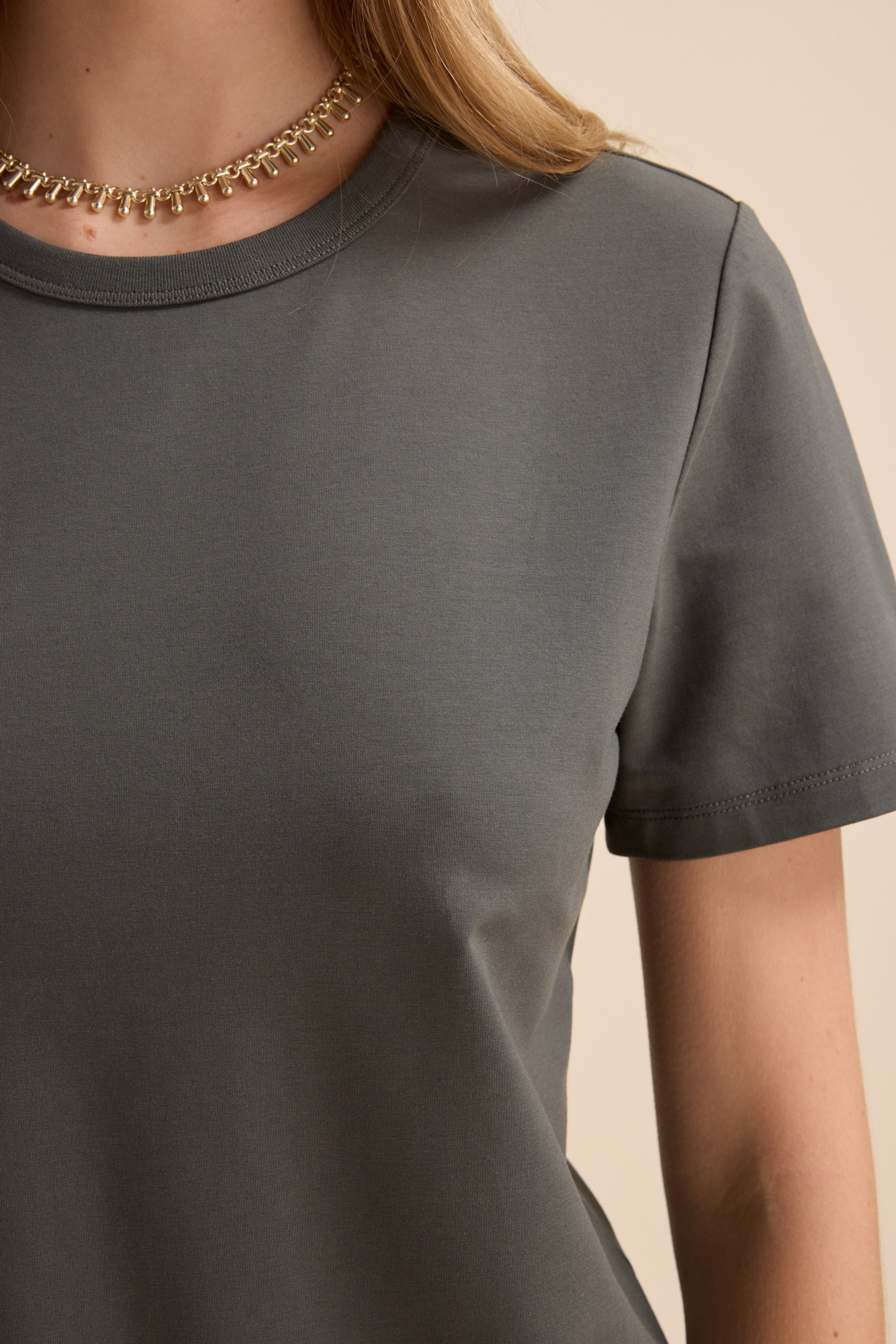 Person wearing Max's Perfect Short Sleeve Crew Neck Tee and a gold chain necklace, shoulders up.