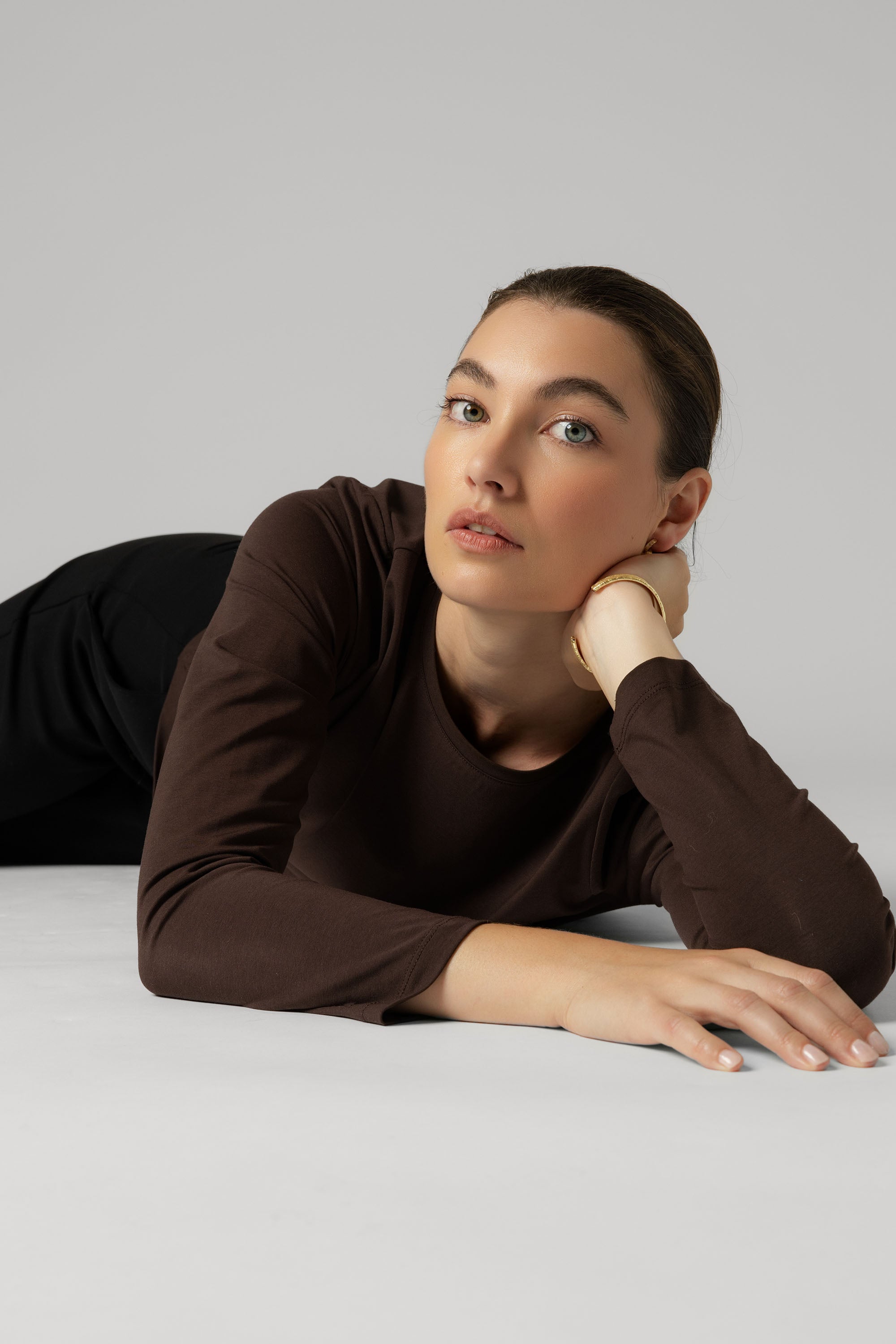 Woman in The Perfect Long Sleeve Crew Tee by Max lies on her side, head resting on her hand.