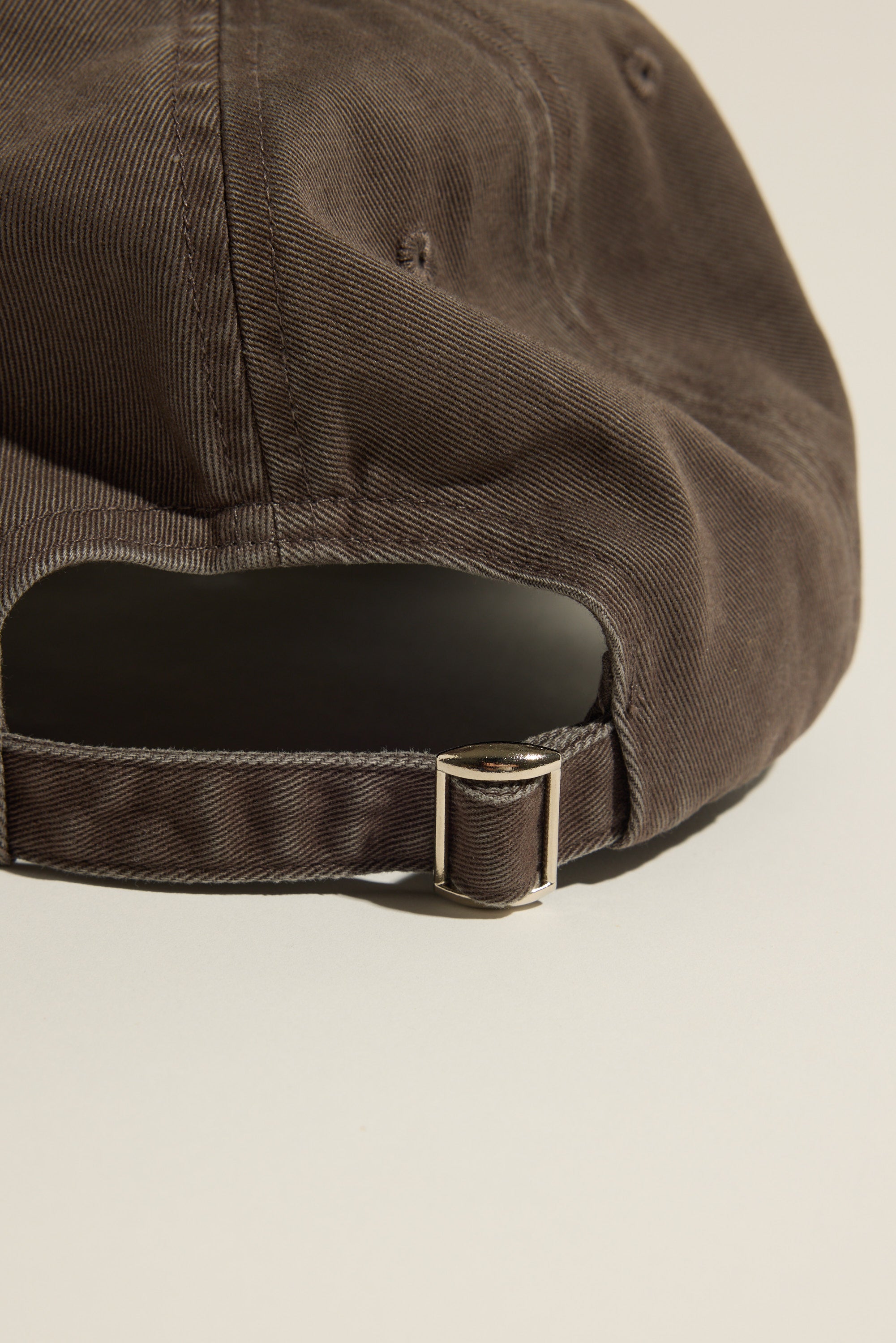 Close-up of the Max Elementary Washed Back Cap with adjustable strap and metal buckle.