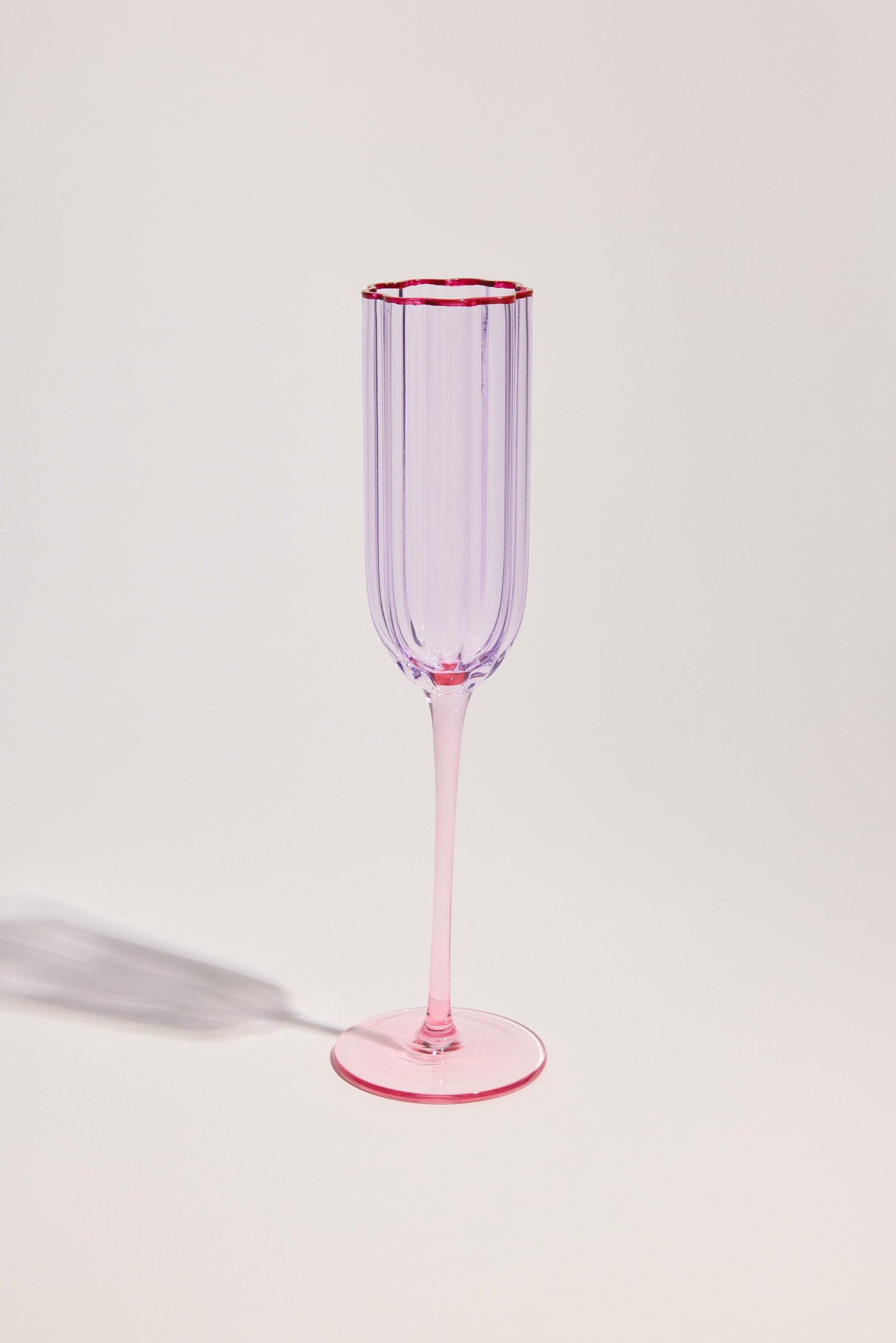 The Homelab Petal Champagne Flute Set features translucent, ribbed petal glasses with lavender bowls and pink stems—perfect for elevating your glassware collection.