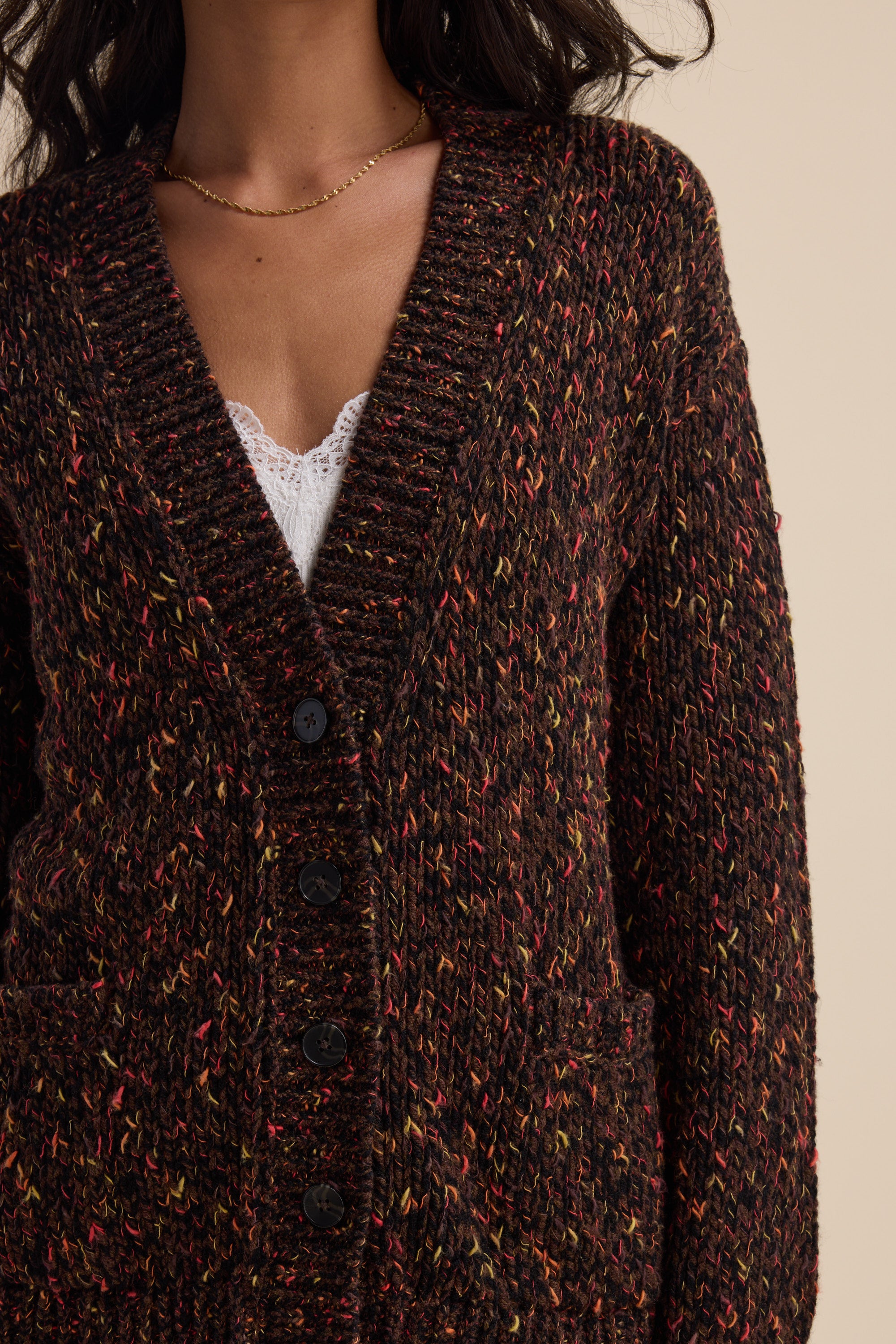 Woman in Elementary Oversized Merino Blend Cardigan over a white lace top.