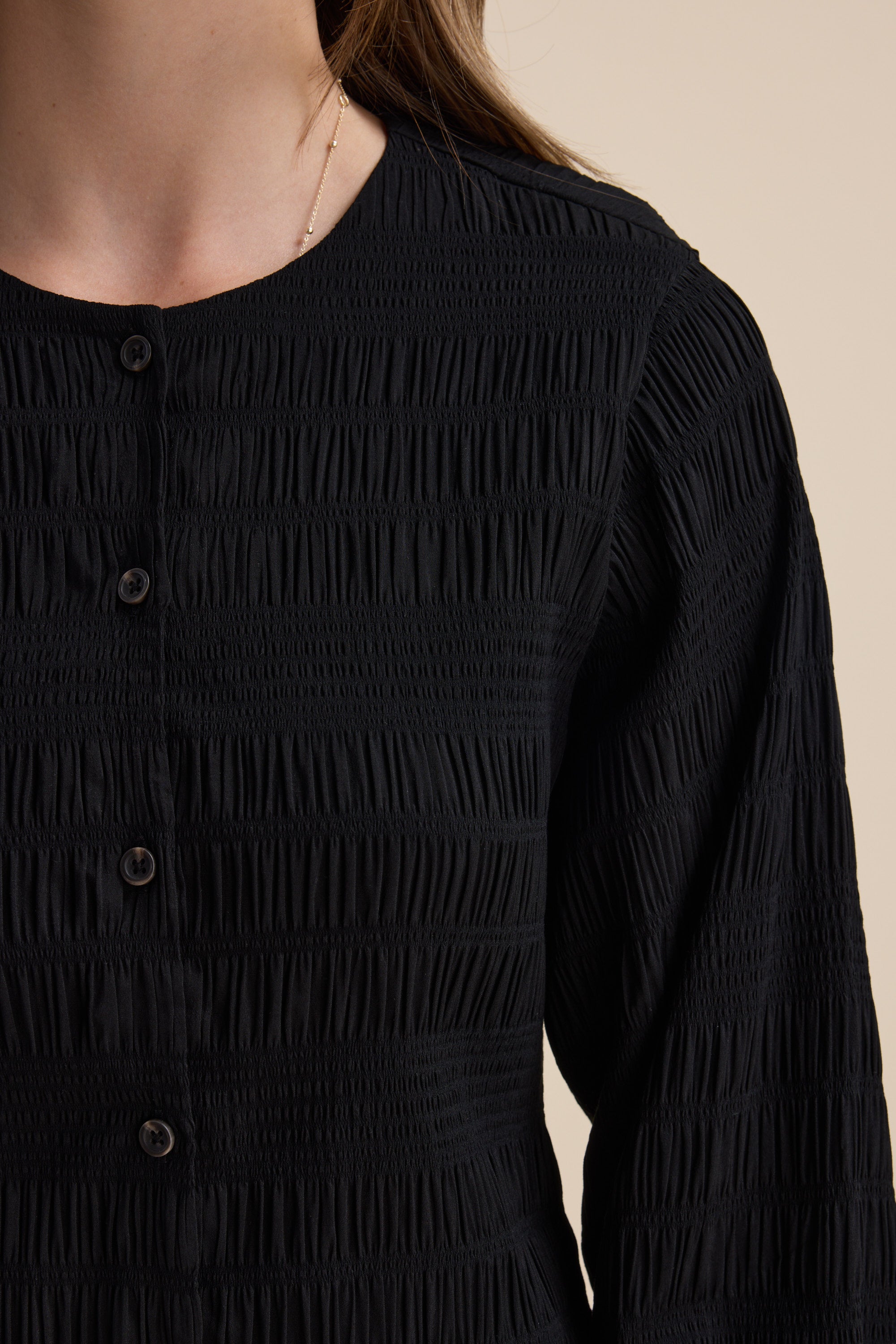 Close-up of a person wearing the Max Tessa Textured Button Front Dress with long sleeves.
