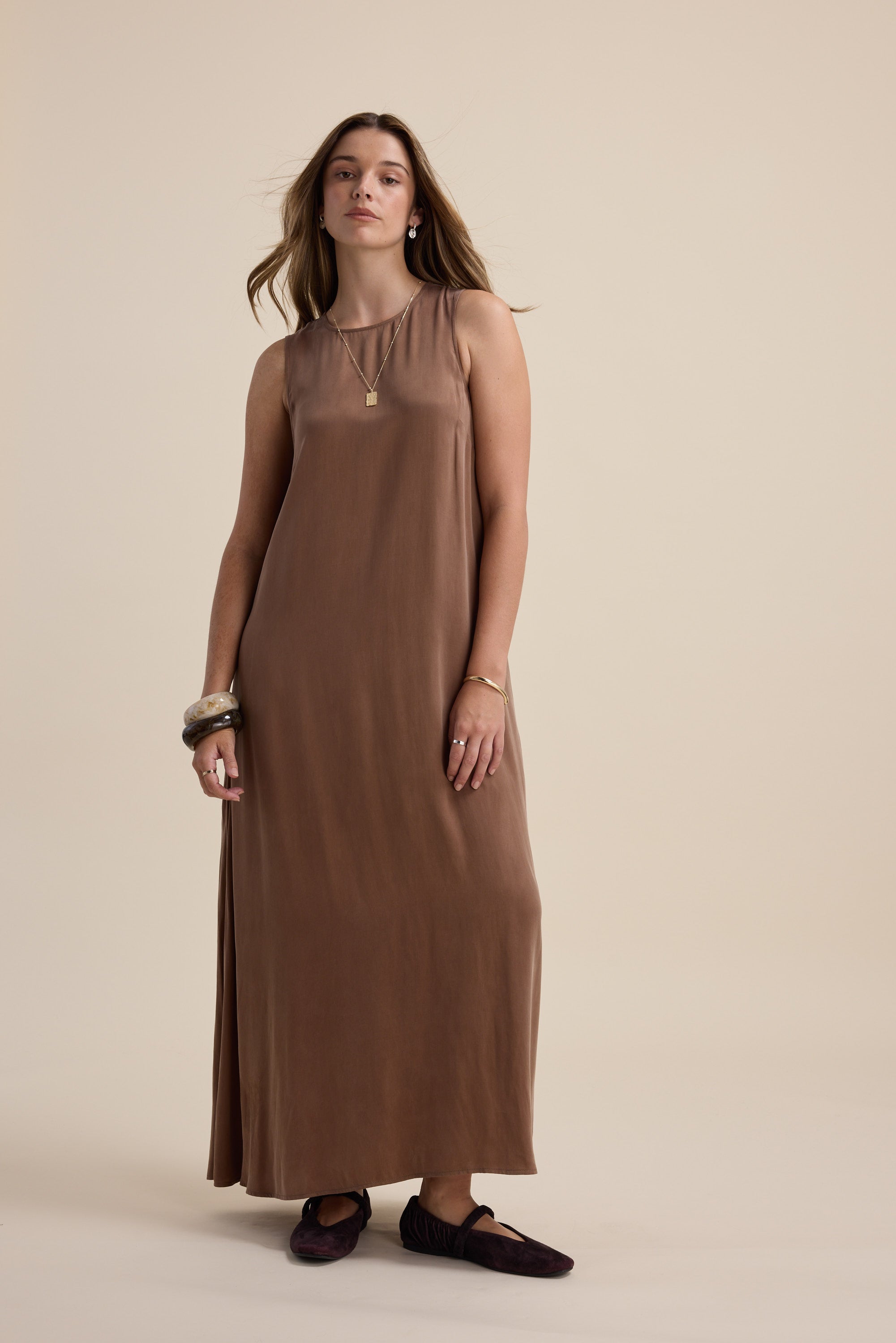 Woman wearing the Max Kaitlyn Flared Midi Dress, standing against a beige background.