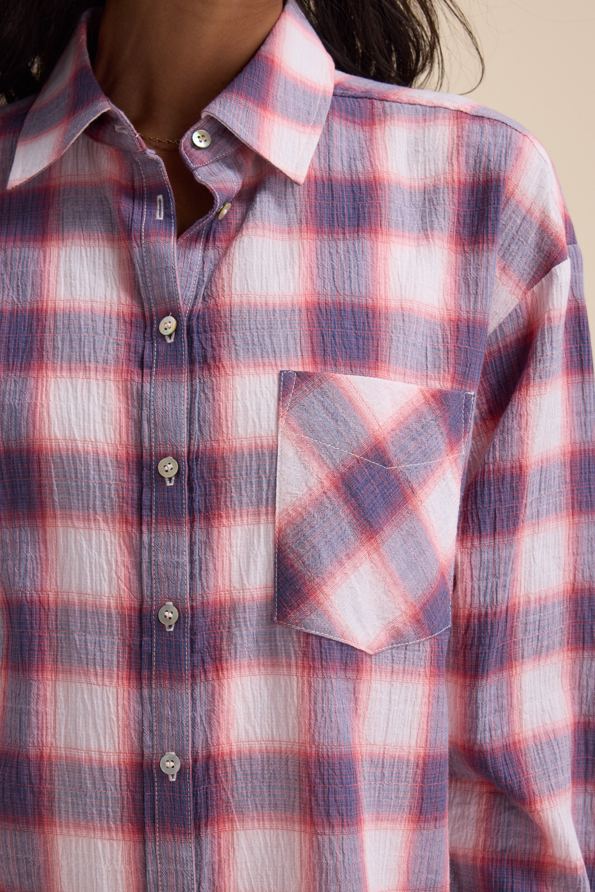 Close-up of a person wearing the Elementary Textured Shirt by Elementary in plaid check.