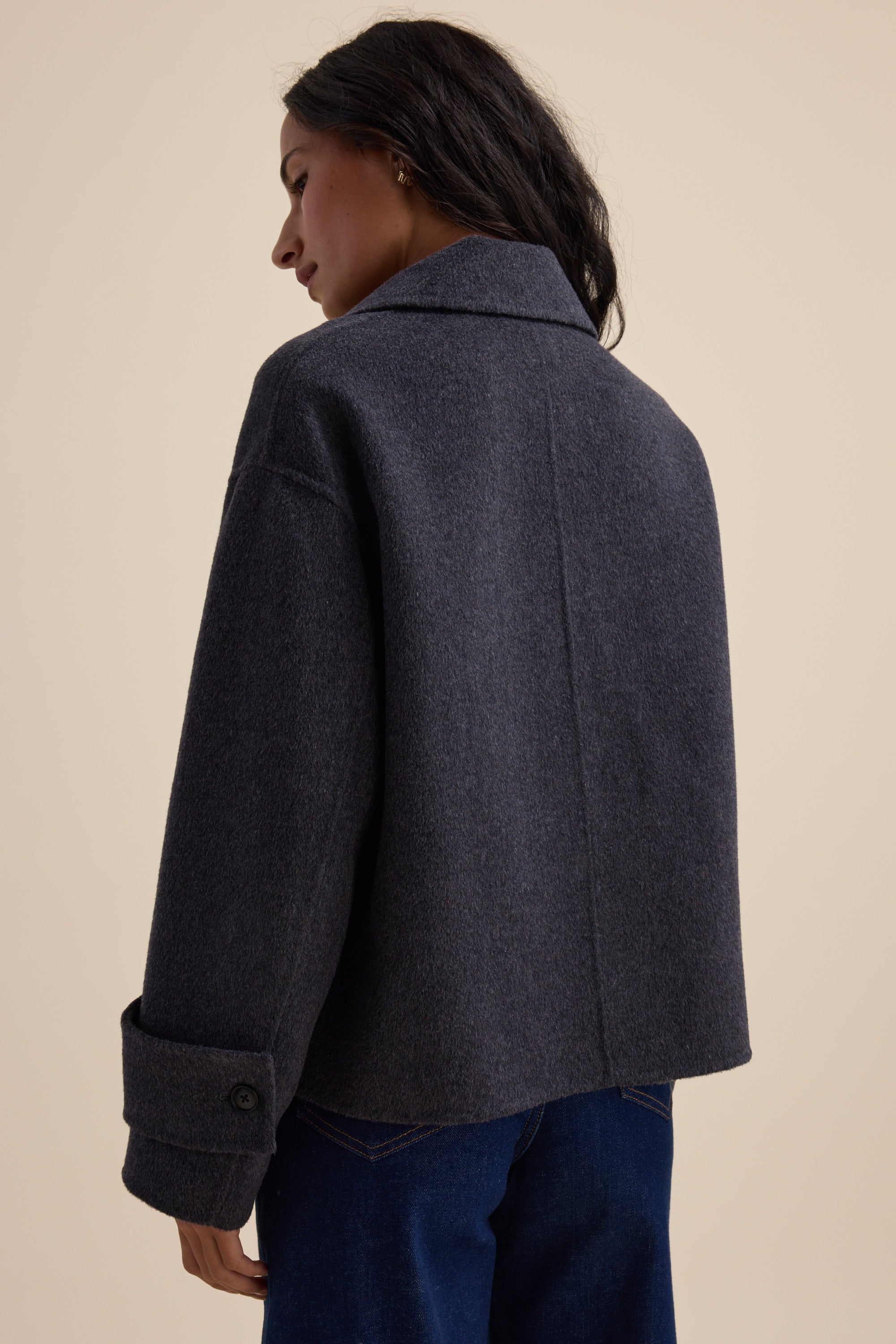 Woman in Max's Double Breasted Wool Blend Coat and blue jeans, shown from the back.