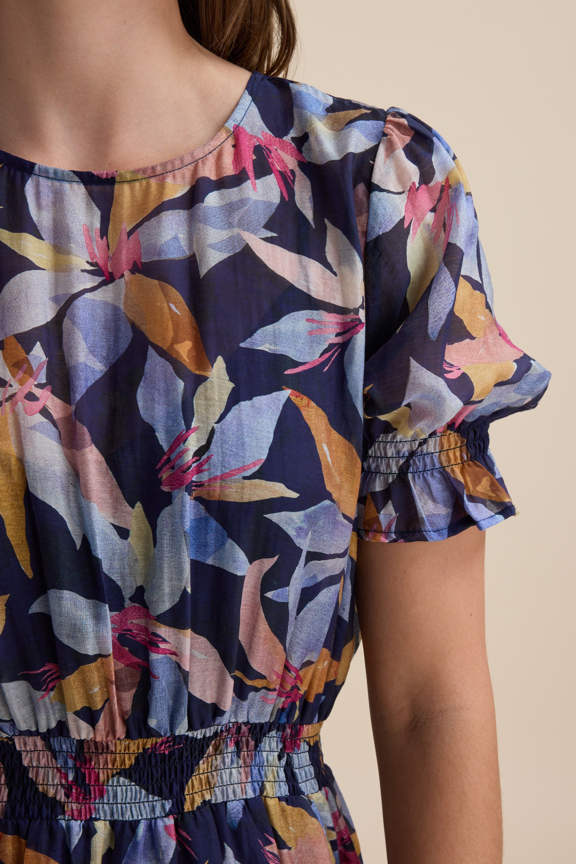 Woman in Max Ava Gather Waist Dress—blue floral midi with short, ruffled puff sleeves.