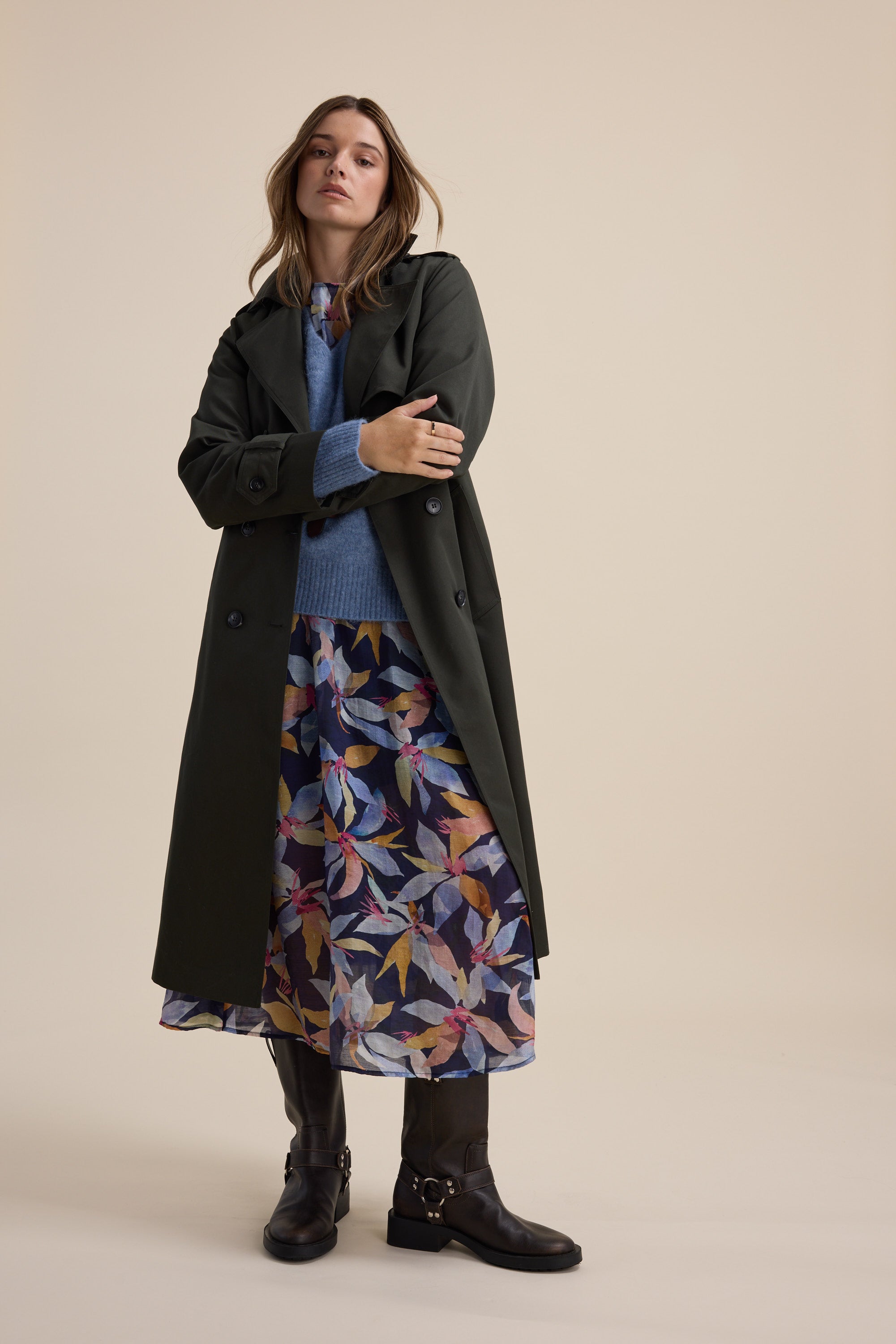 Woman in a Max Ava Gather Waist Dress with puff sleeves and black boots, standing indoors.