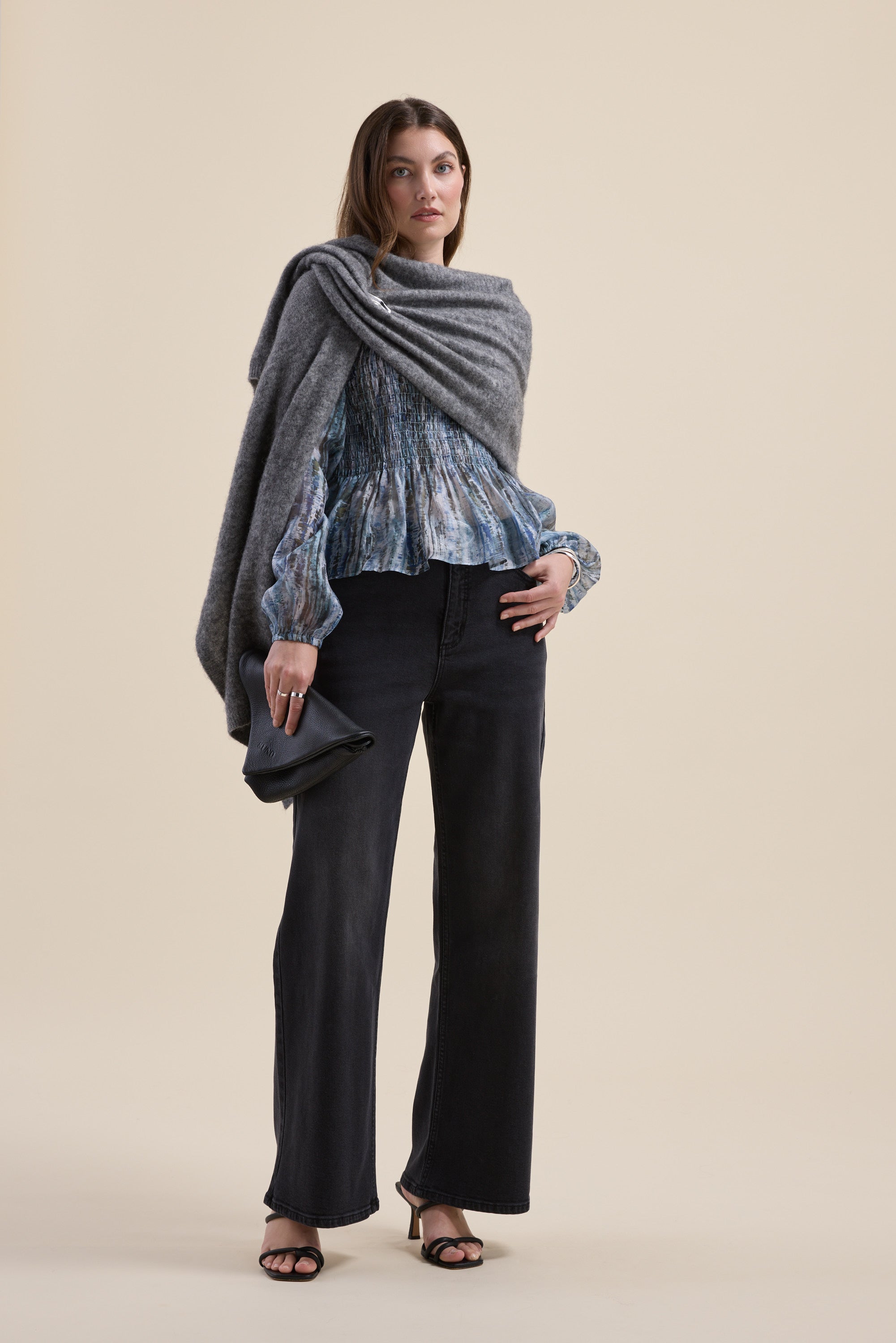Woman in Mitch Shirred Top by Max, wide-leg black pants, gray shawl, clutch, neutral backdrop.