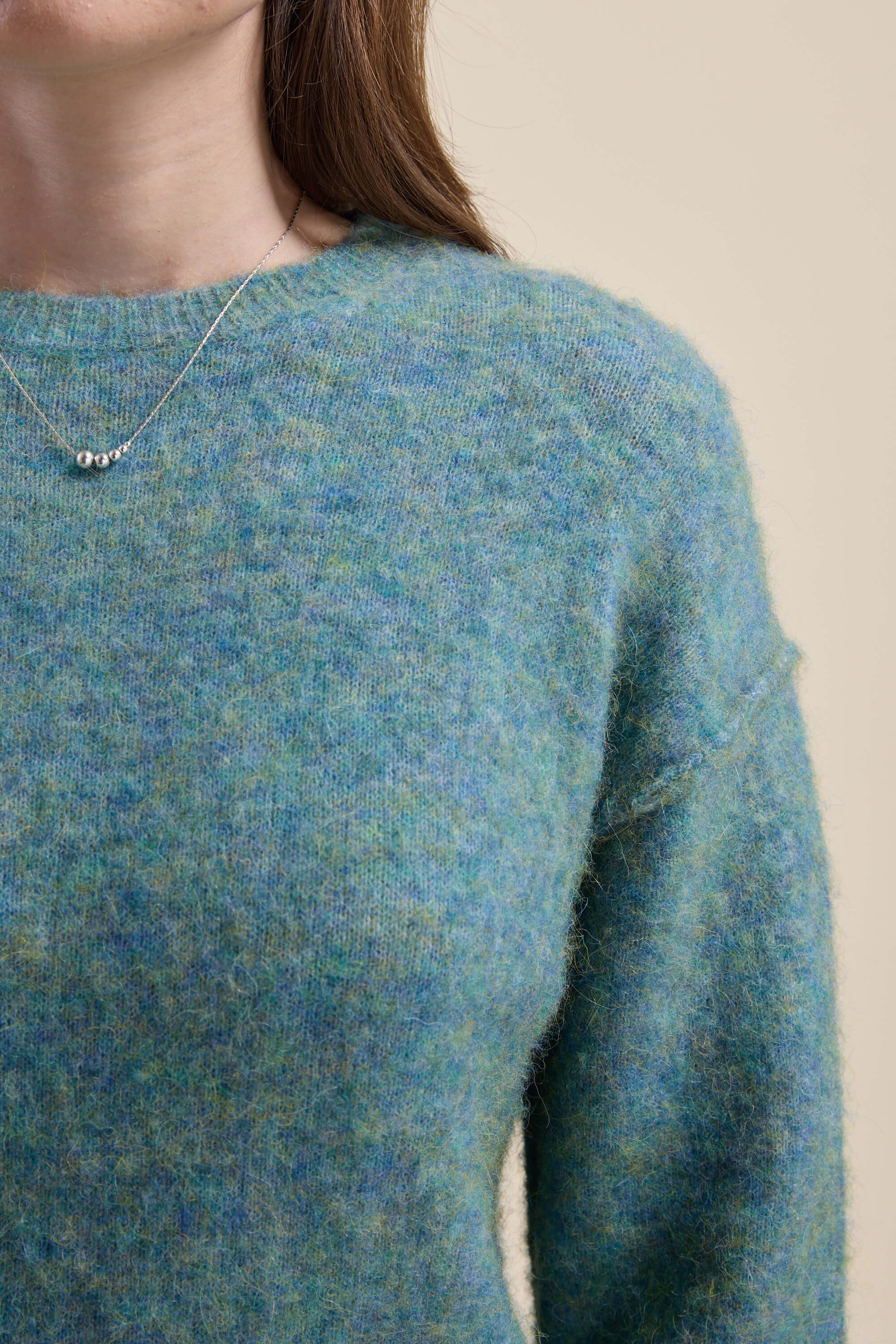 Person wearing a Max Devon Luxe Whisper Crew Neck Sweater and a silver beaded necklace.