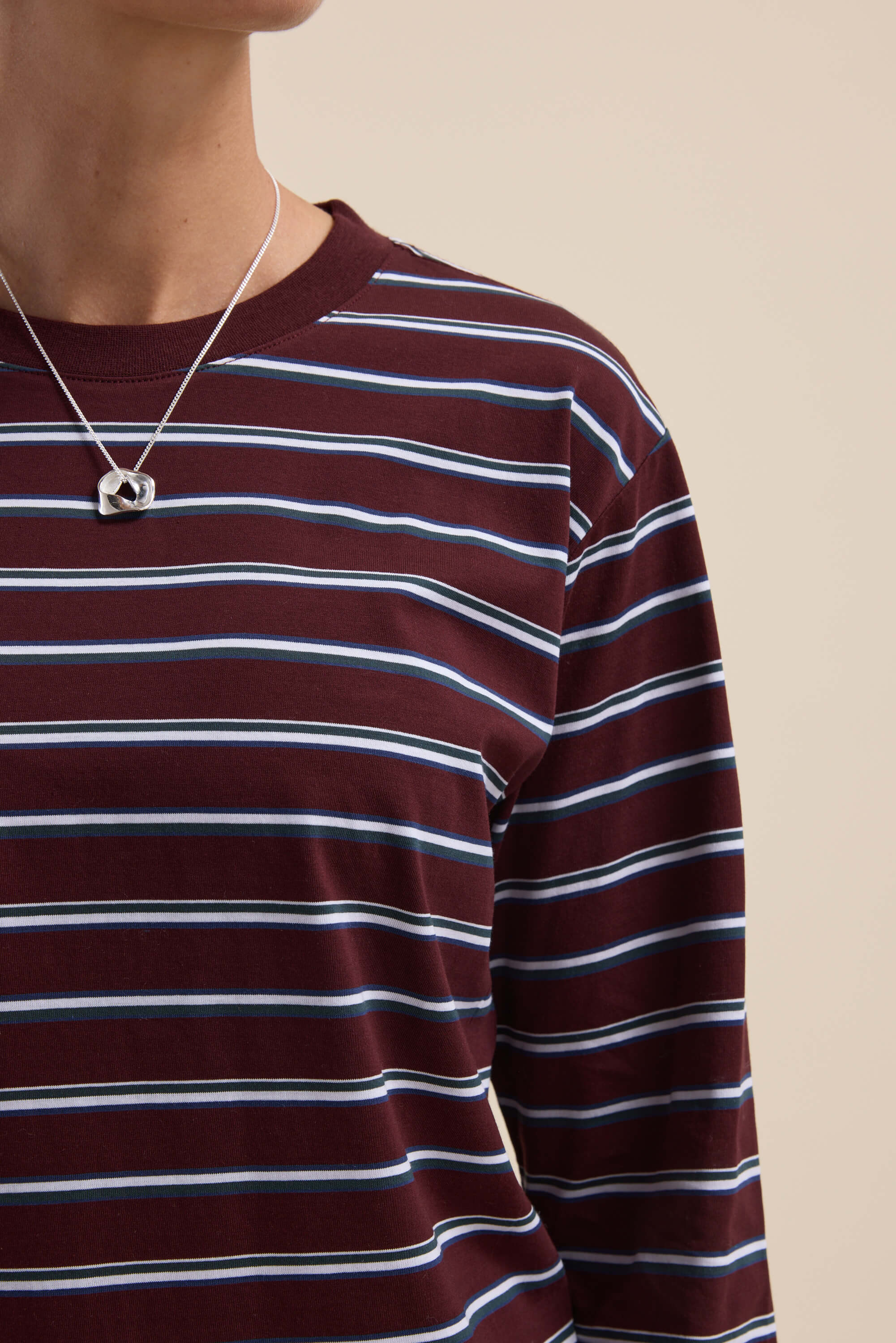 Person wearing the Max Carmen Long Sleeve Stripe Tee with a silver heart necklace.