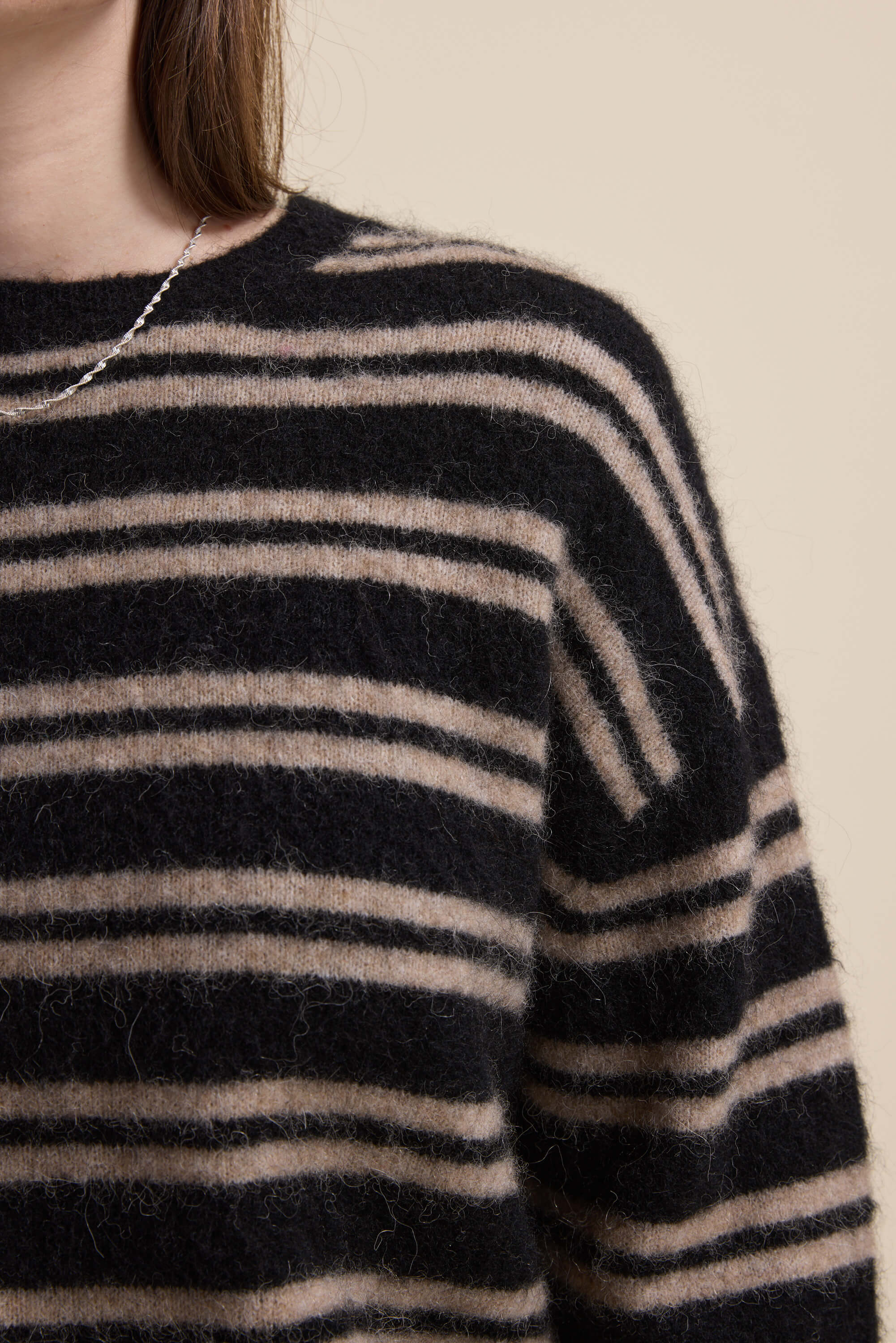 Close-up of Max Juno Luxe Whisper Sweater with beige stripes and a glimpse of a necklace.