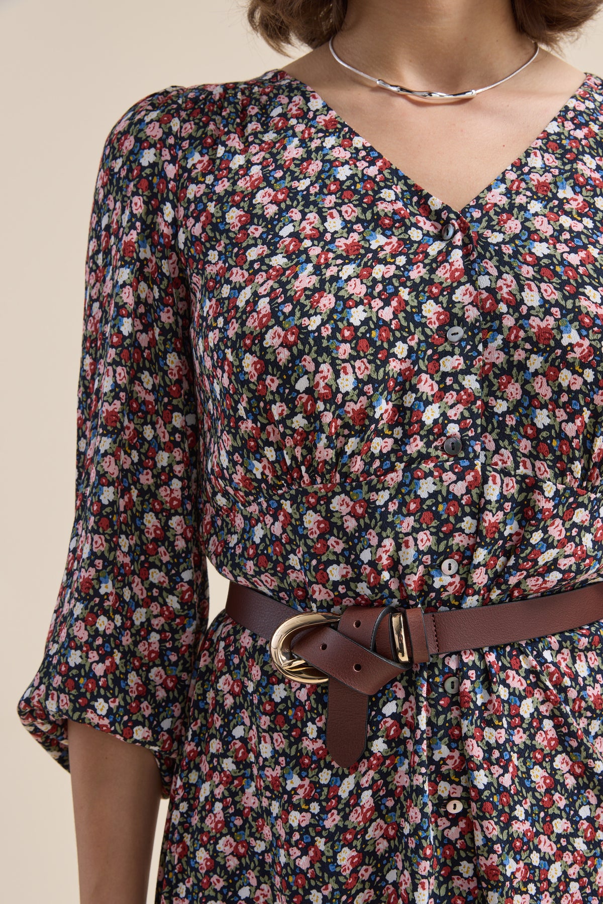 Model in Elementary Button Front Dress by Elementary, shown from shoulders to waist.
