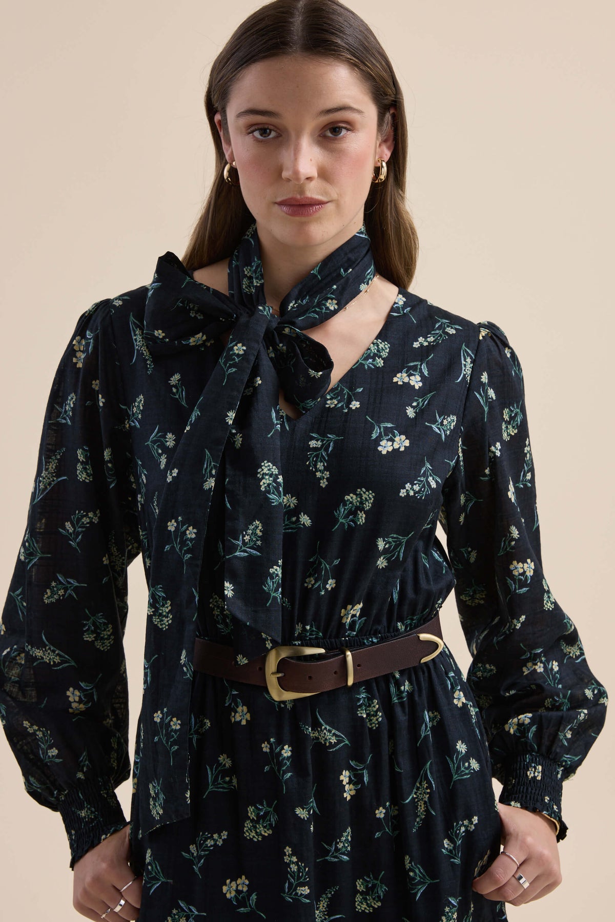 Woman in an Elementary Tiered Dress by Elementary, standing indoors.
