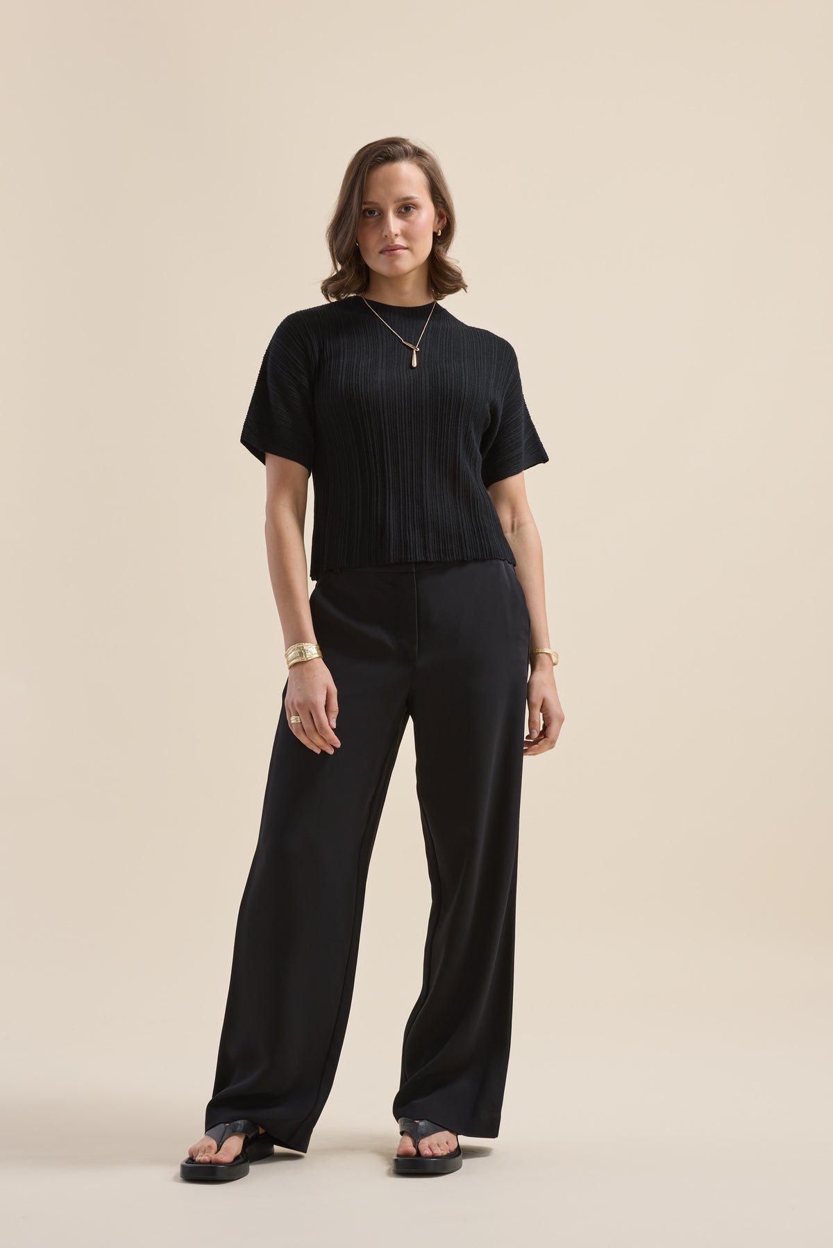 Woman in The Merino Silk Knit Detail Tee by Max, wide-leg pants, sandals, jewelry, confident.