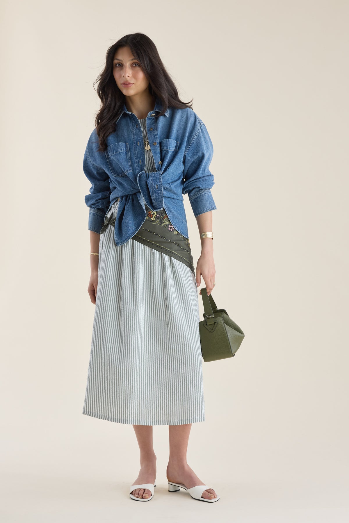 Woman in Talia Shirred Detail Midi Dress by Max, sandals, green bag, and olive crossbody belt bag.