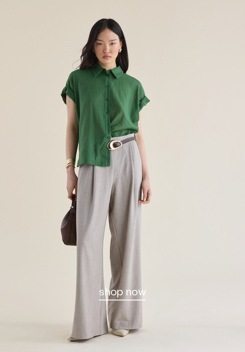 A woman wearing the pleat front pants