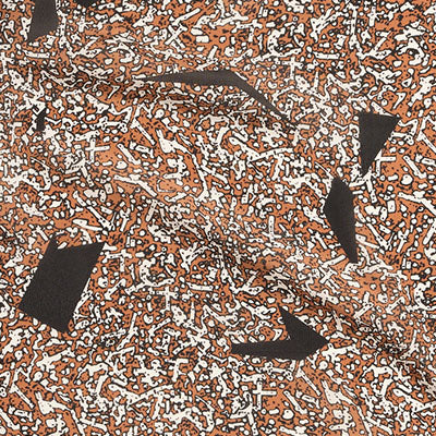 Abstract orange, white, and black NZ-inspired pattern with scattered black geometric shapes.