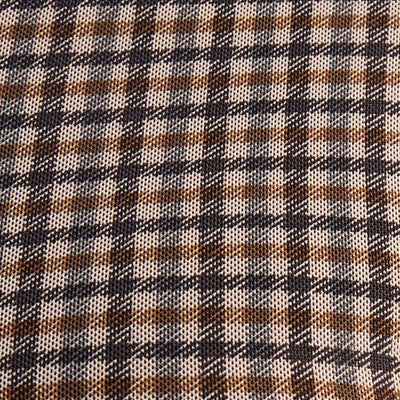 A close-up of brown, white, and black NZ plaid patterned fabric.